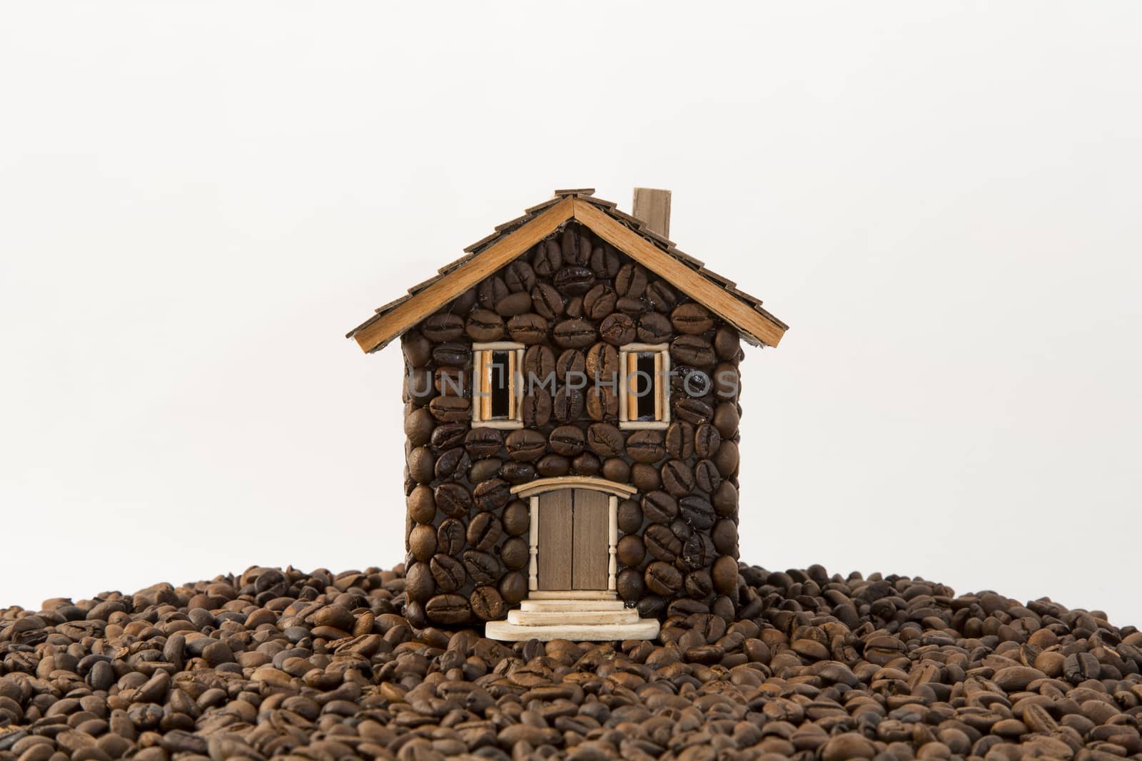 House made of coffee on white background