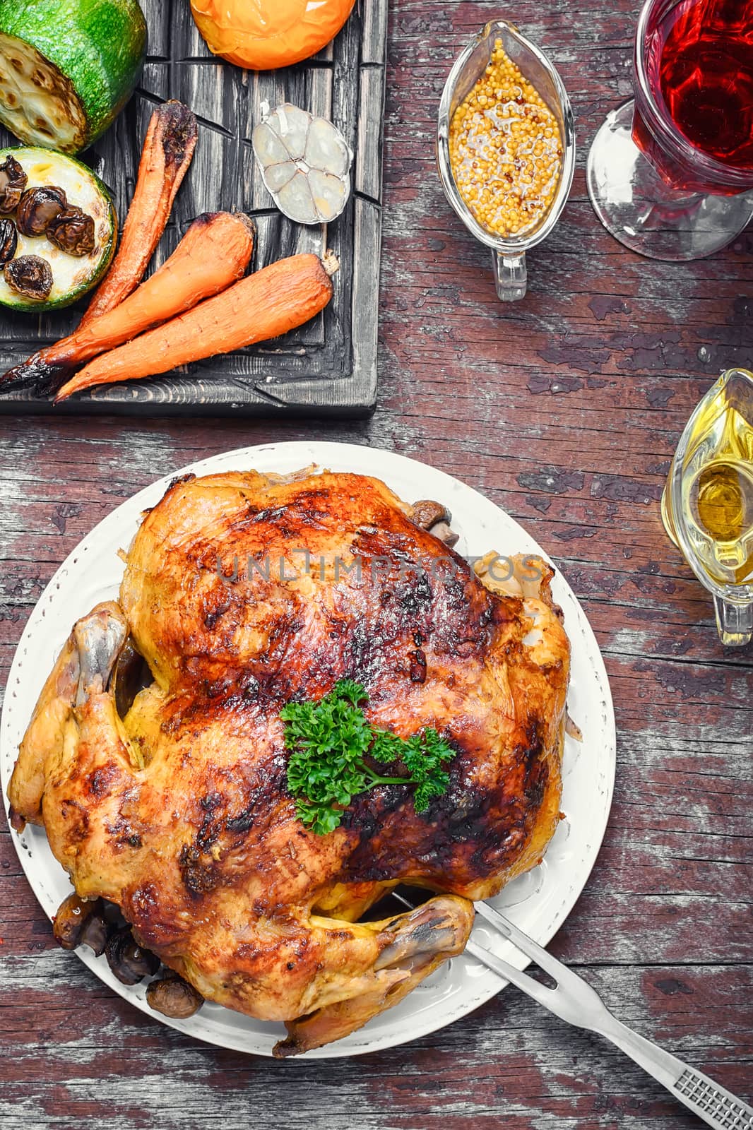 Chicken cooked in vegetables on vintage wooden surface