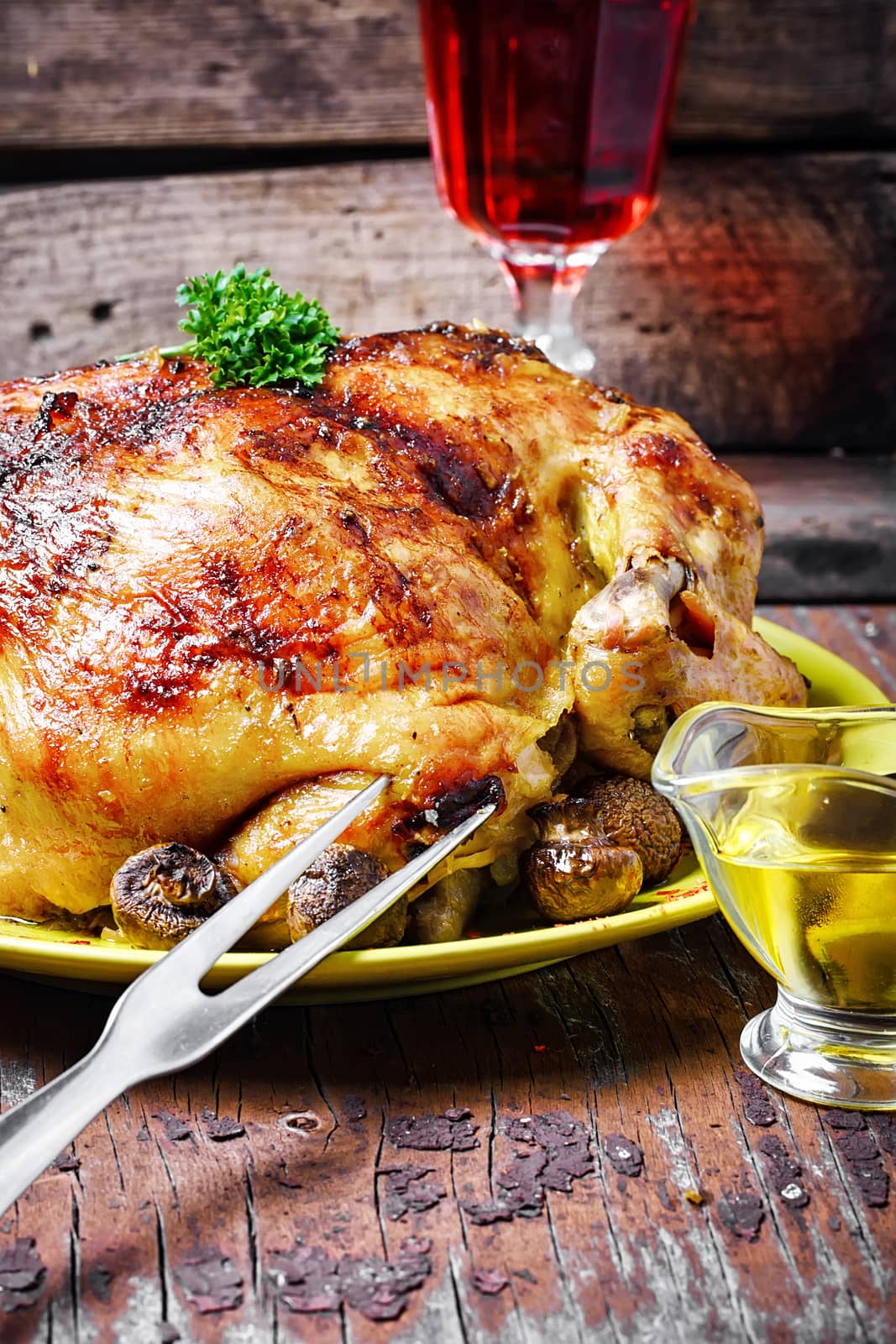 Chicken cooked in vegetables on vintage wooden surface
