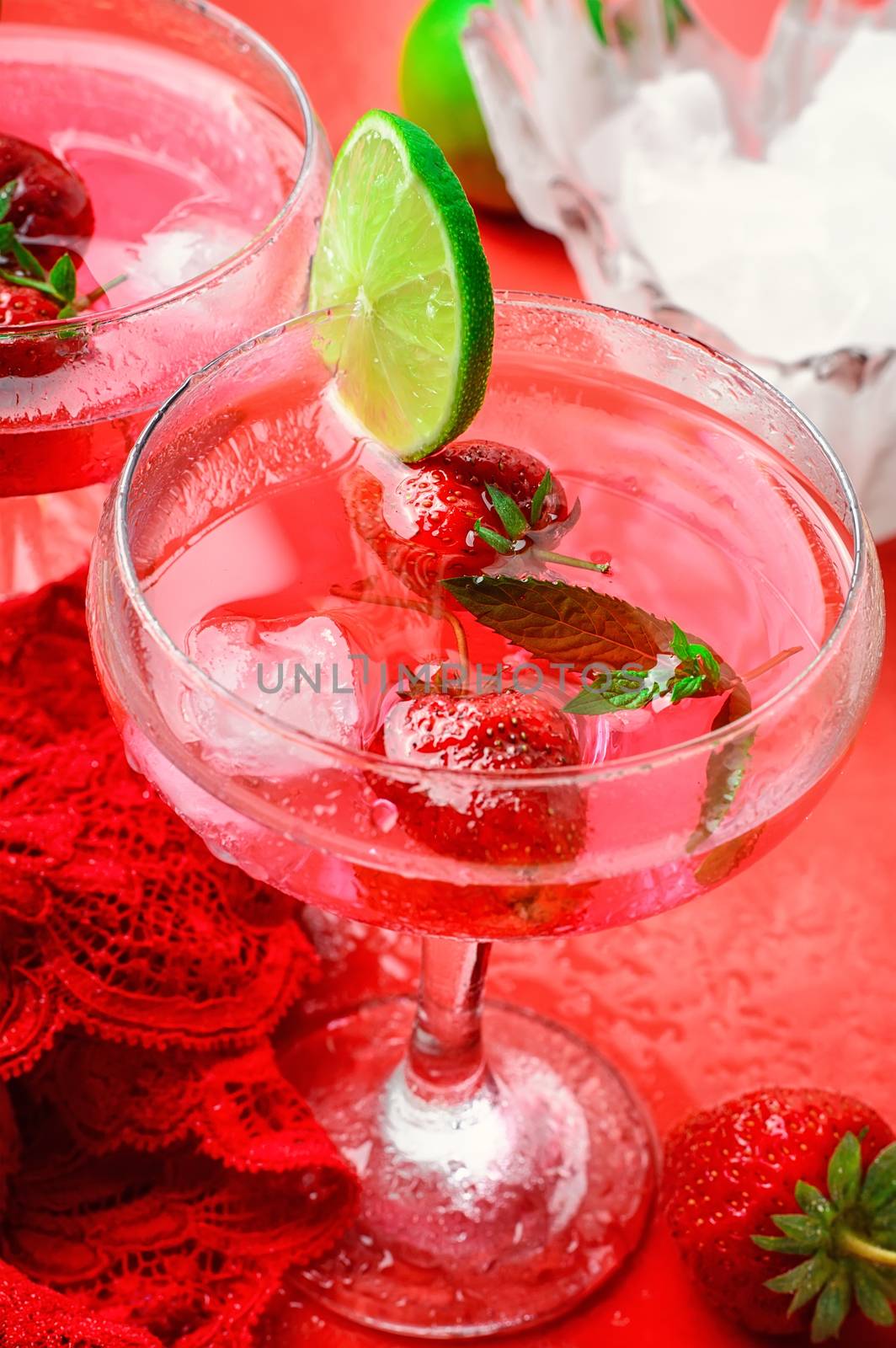 Freshly made strawberry mojitos with ice and romantic lace