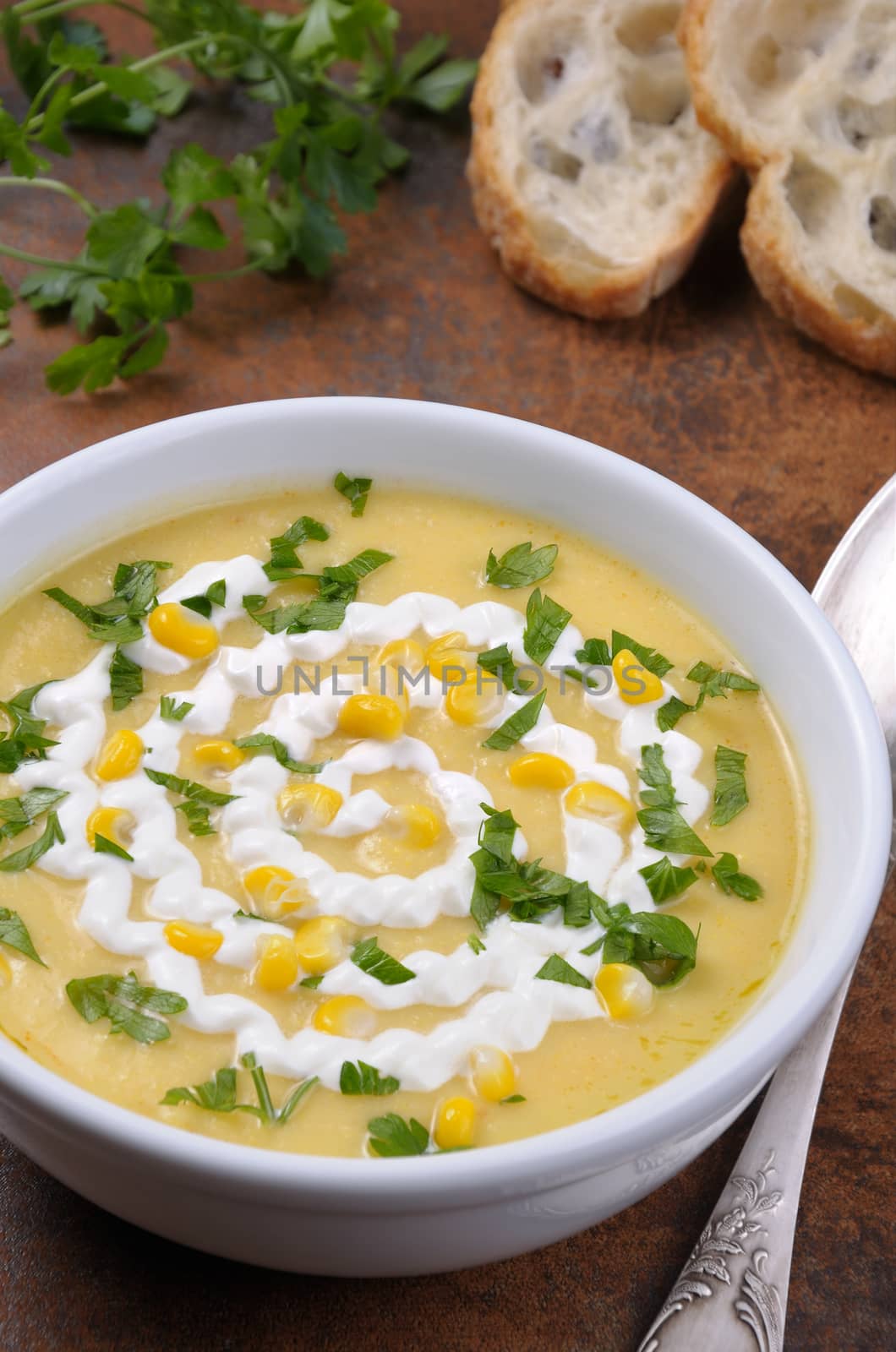 Puree soup mealies seasoned with grains of corn, parsley and sour cream