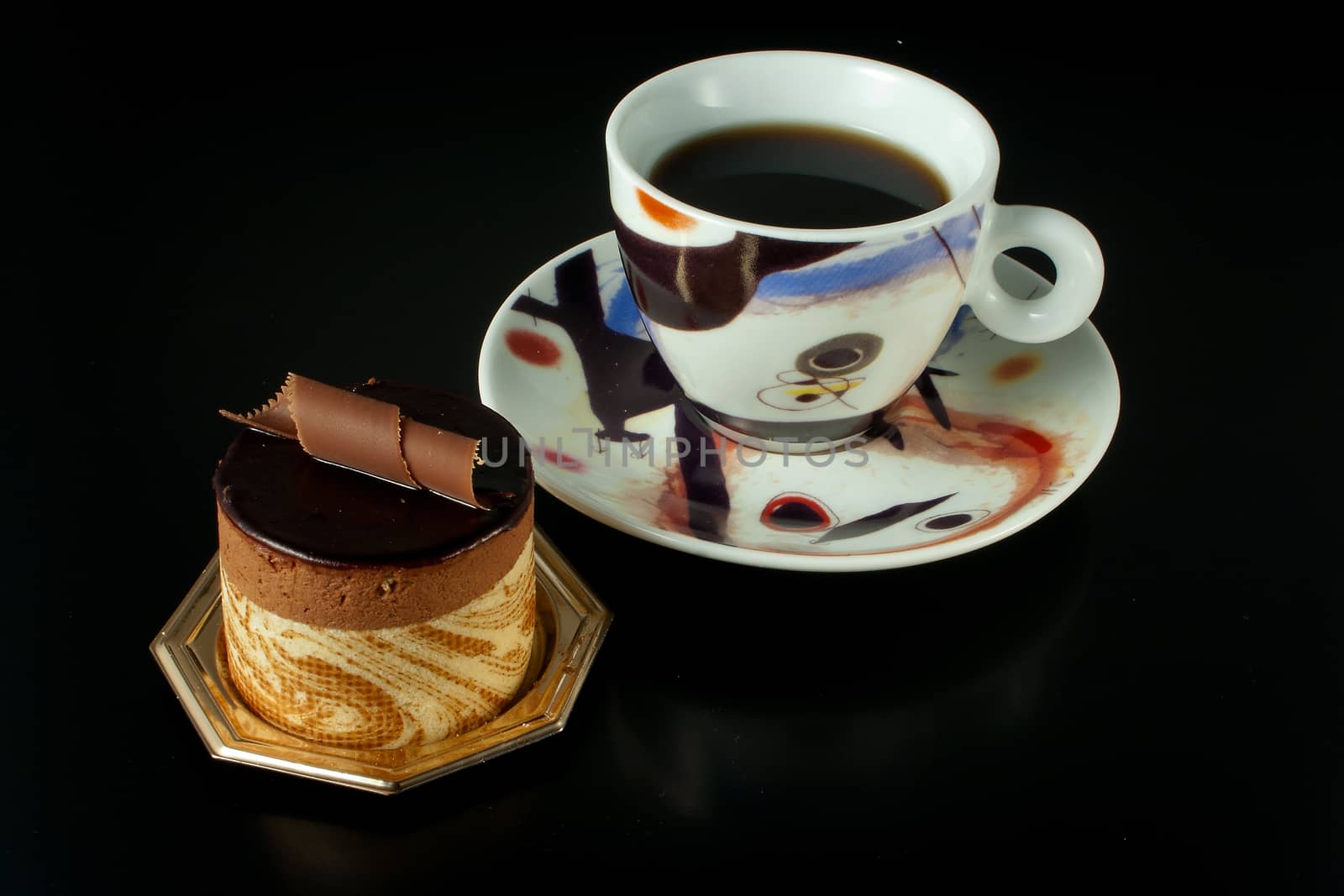 Tasteful Chocolate Pastry mousse isolated on black background with cup of coffee