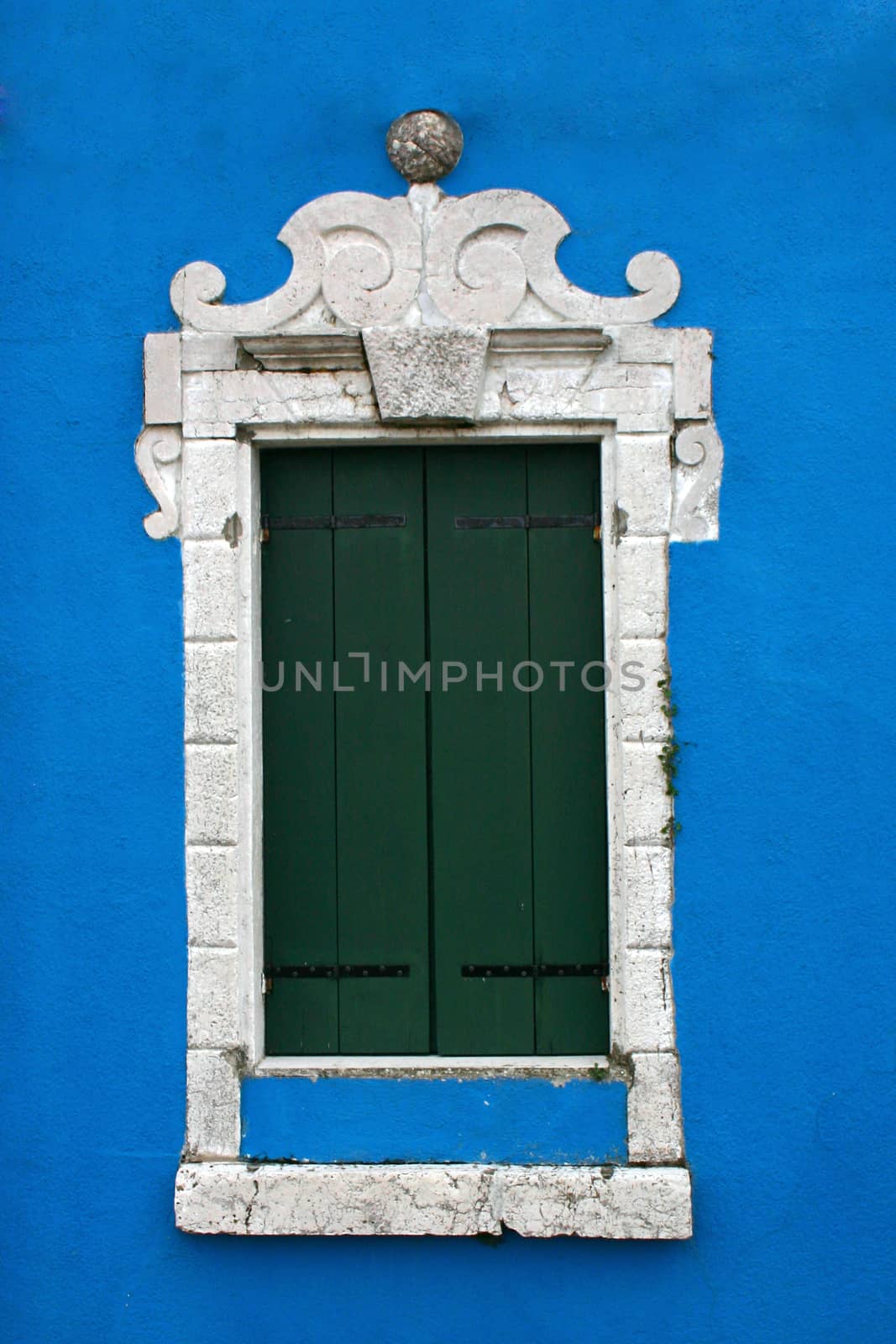 Window of one of the colored houses in Burano - Venice - Italy