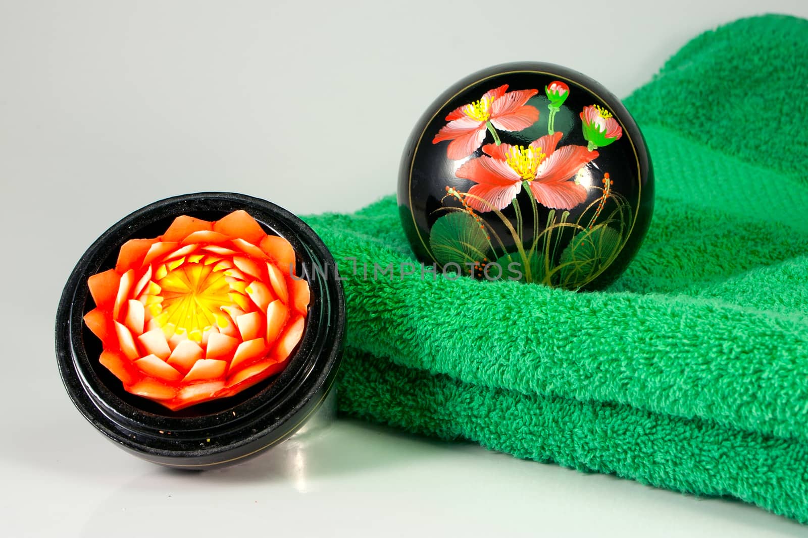 Aromatic blossom candle and green towel
