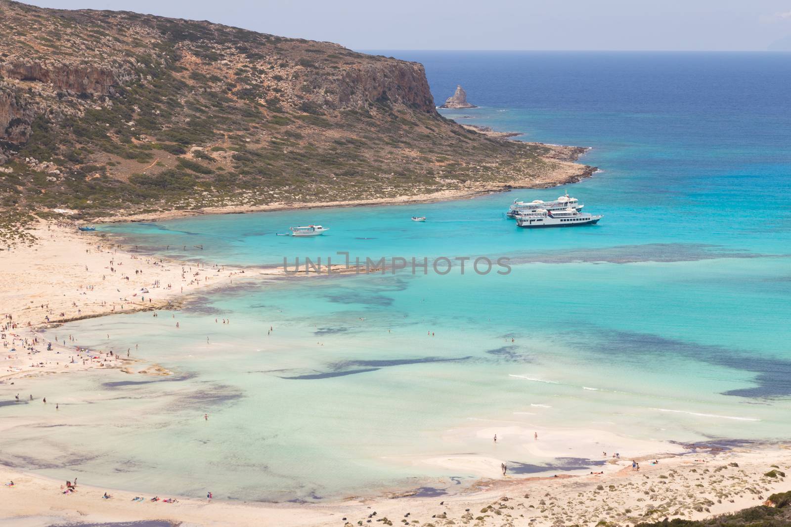 Breathtaking panorama of Balos beach and lagoon and Gramvousa island on Crete, Greece. Tourist boats mooring in lagoon.
