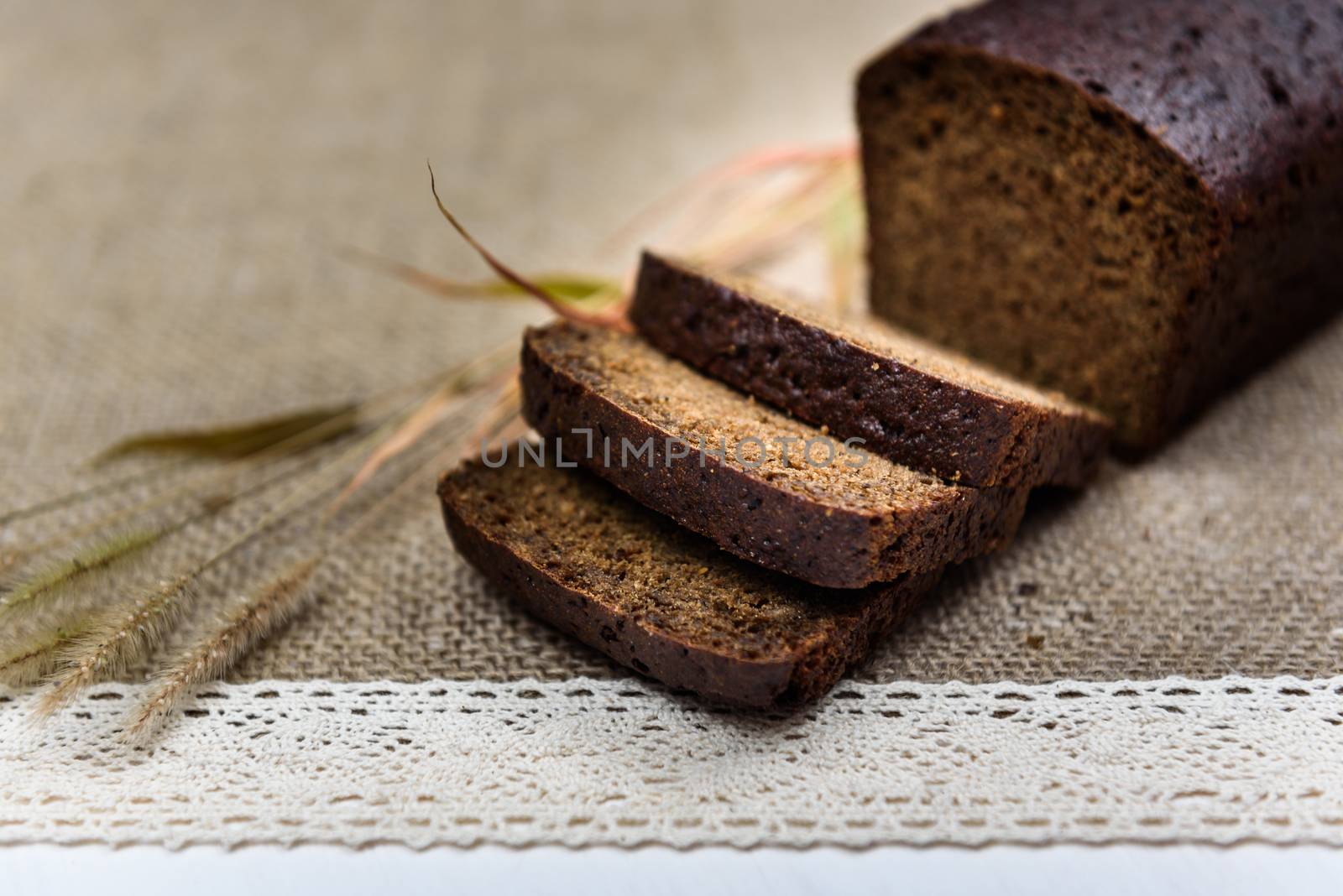 black bread on burlap with ears on a white board