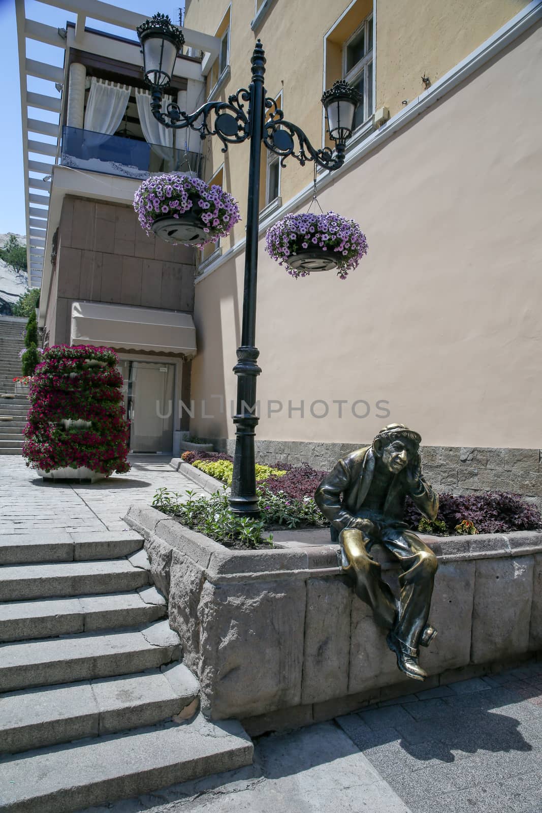 The bronze man put his hand to his ear.