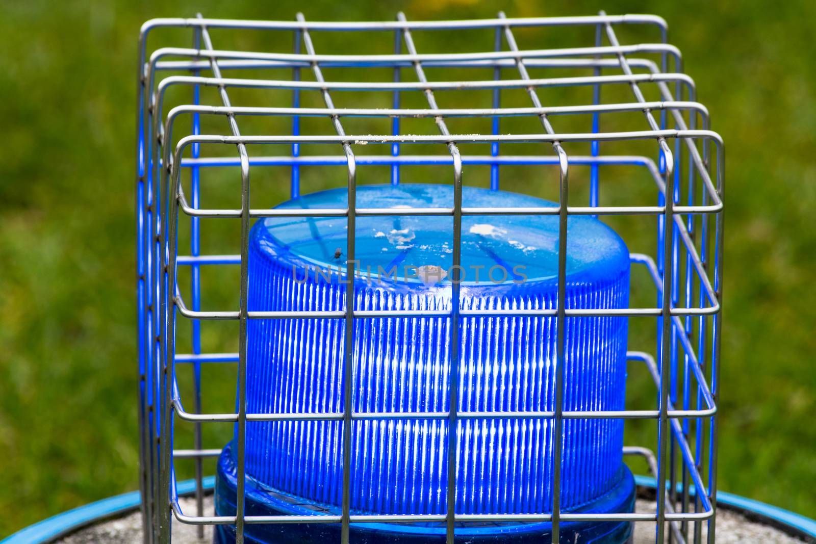 Blue flashing light, police siren  against destruction with wire sheathed.