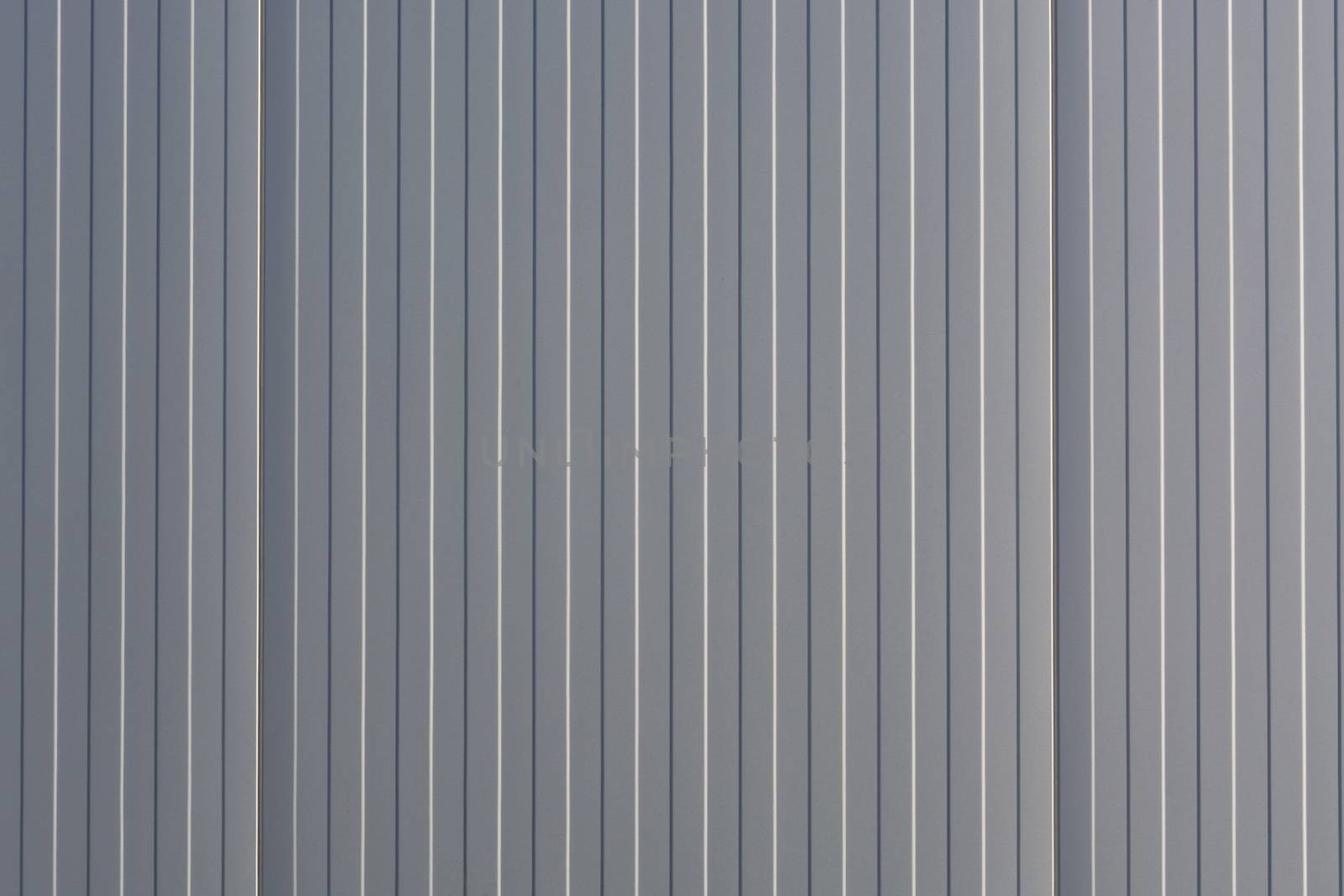 Silver-colored metal wall corrugated sheet metal background.