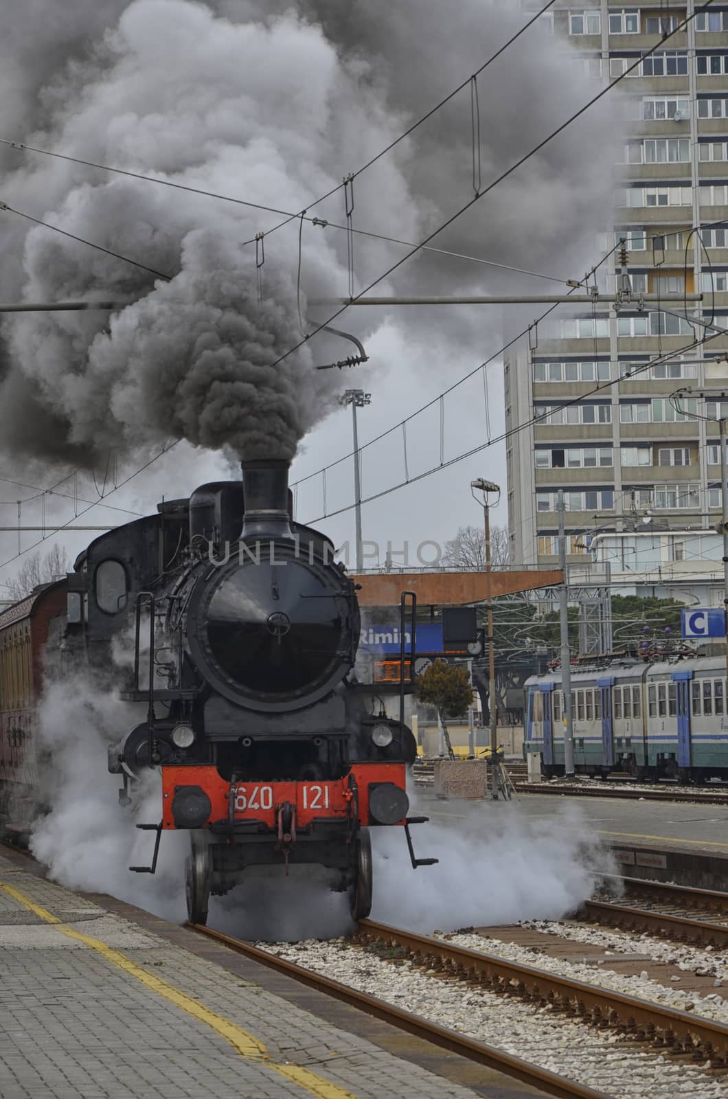 View of steam locomotive leaving the station