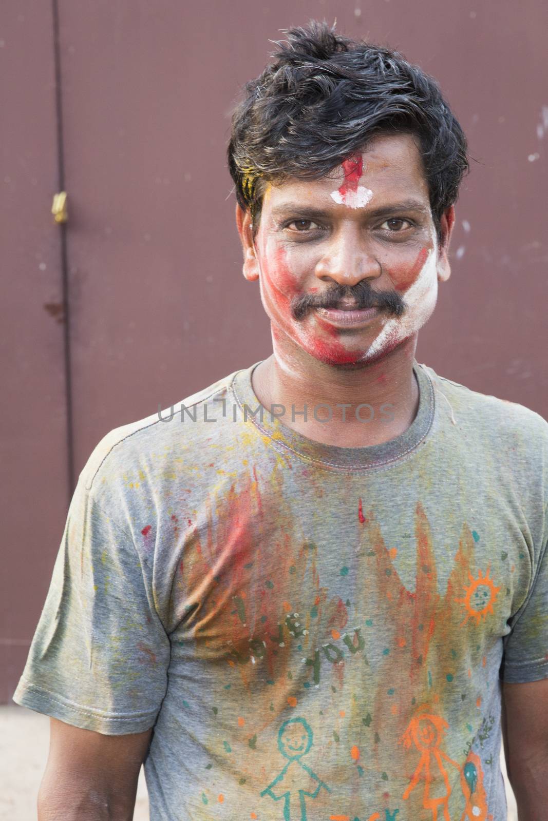 Pondicherry, Tamil Nadu,India - May 15, 2014 : each year in villages, people celebrate the temple fest, for the full day. They walk in groups, they launch paint on people, play music.