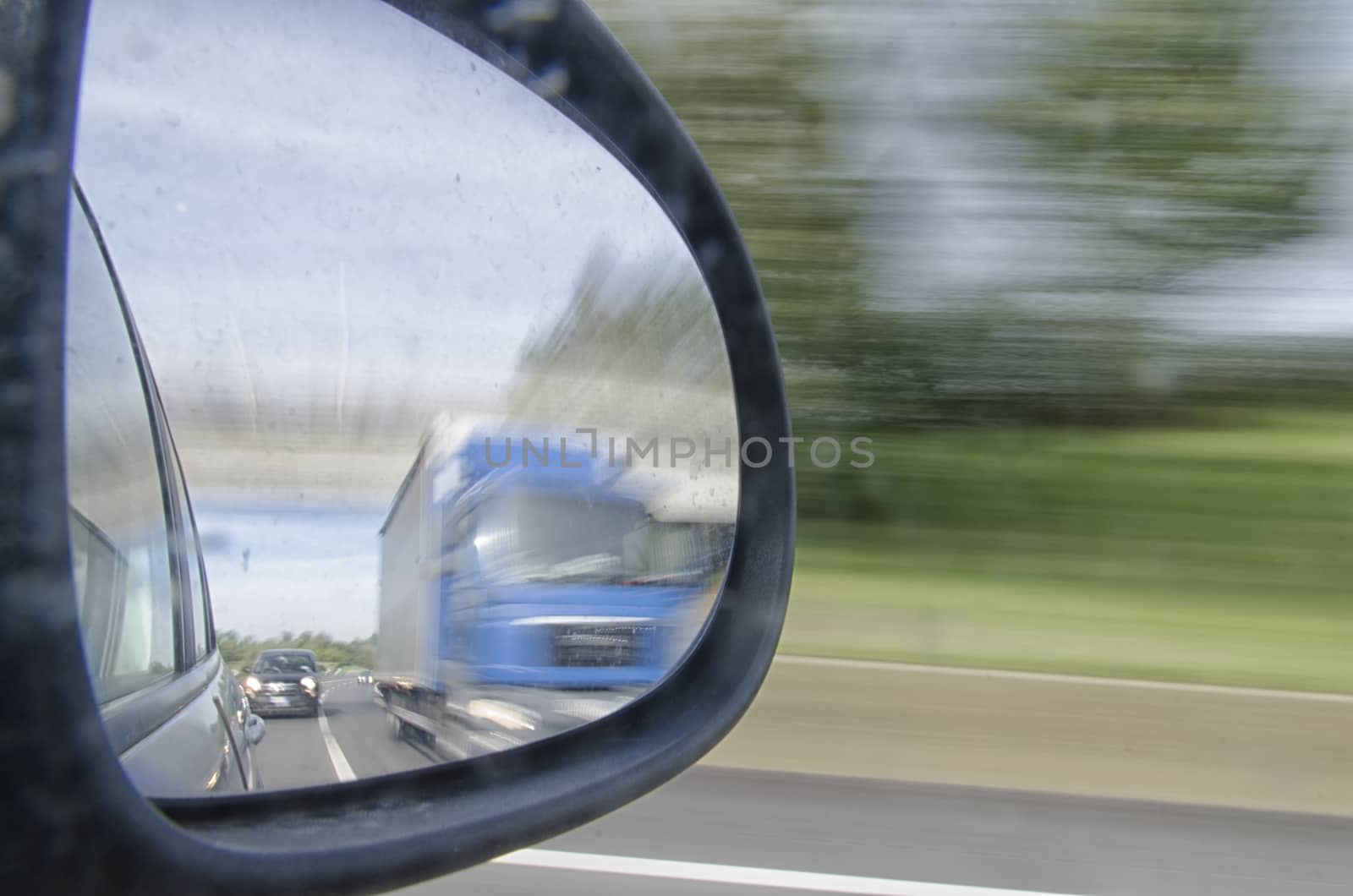Overtaking a truck seen in the rearview mirror