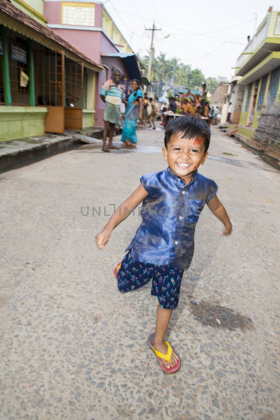 Pondicherry, Tamil Nadu,India - May 15, 2014 : each year in villages, people celebrate the temple fest, for the full day. They walk in groups, they launch paint on people, play music.