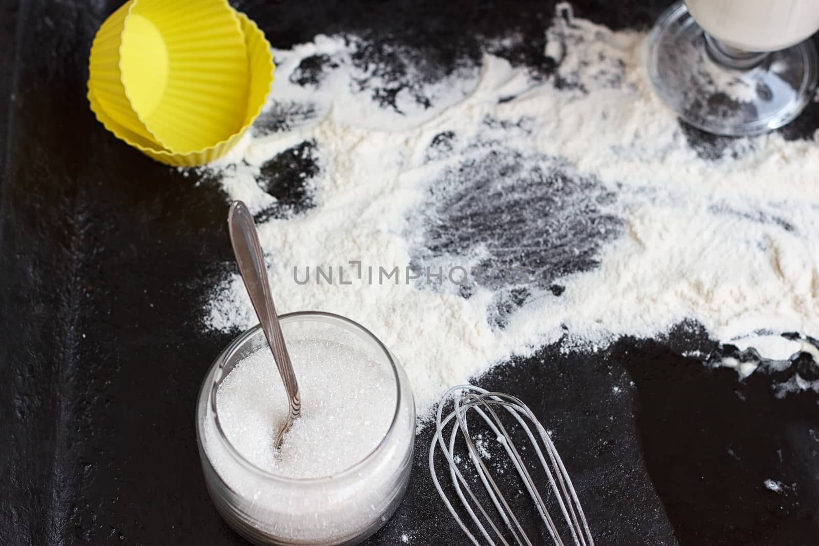 Ingredients for a cake on a black natural stone
