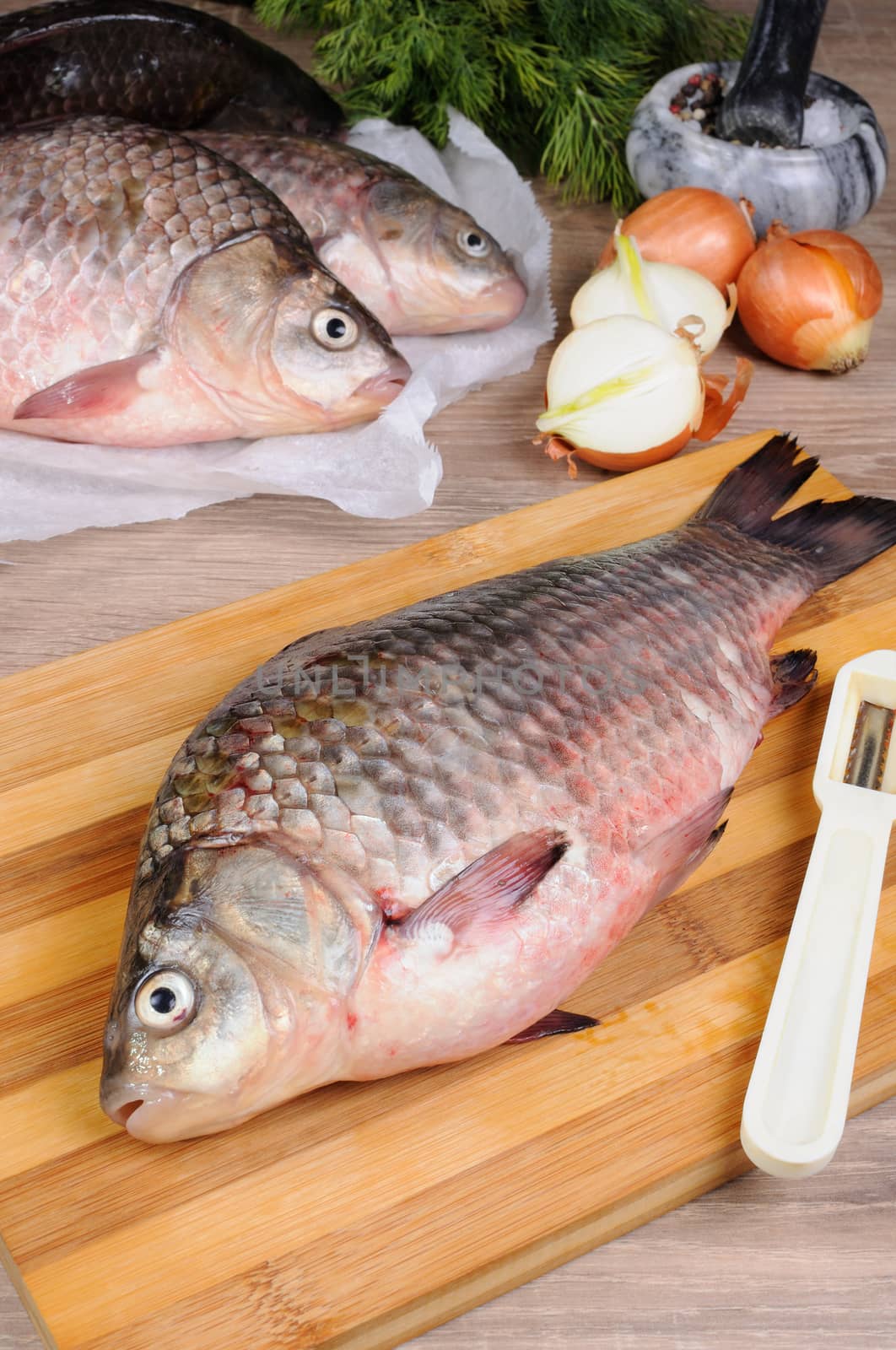 Fresh crucian carp lying on a cutting board for cutting cooked