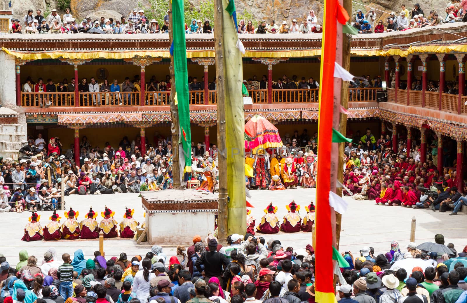 Hemis, India -  June 29, 2012: courtyard of the monastery during the Cham Dance Festival of Tibetan buddhism, full of spectators and performers in Hemis monastery, India.