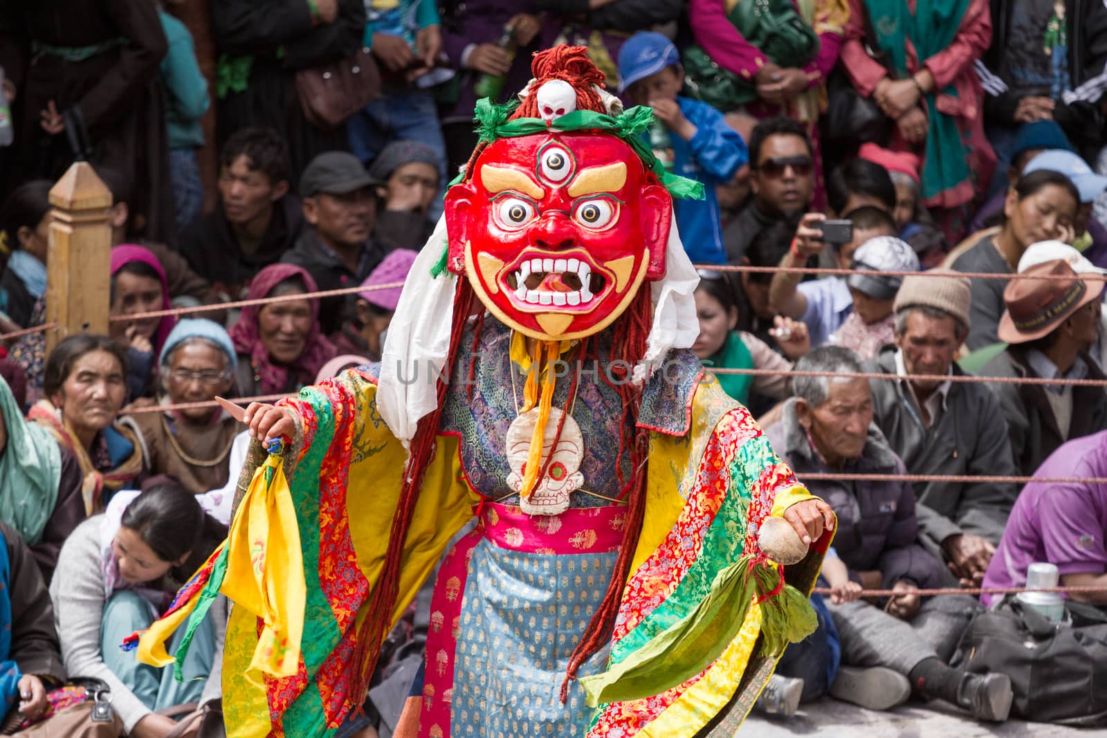 Unidentified monk with phurpa performs a religious masked and costumed mystery dance of Tibetan Buddhism during the Cham Dance Festival by straannick