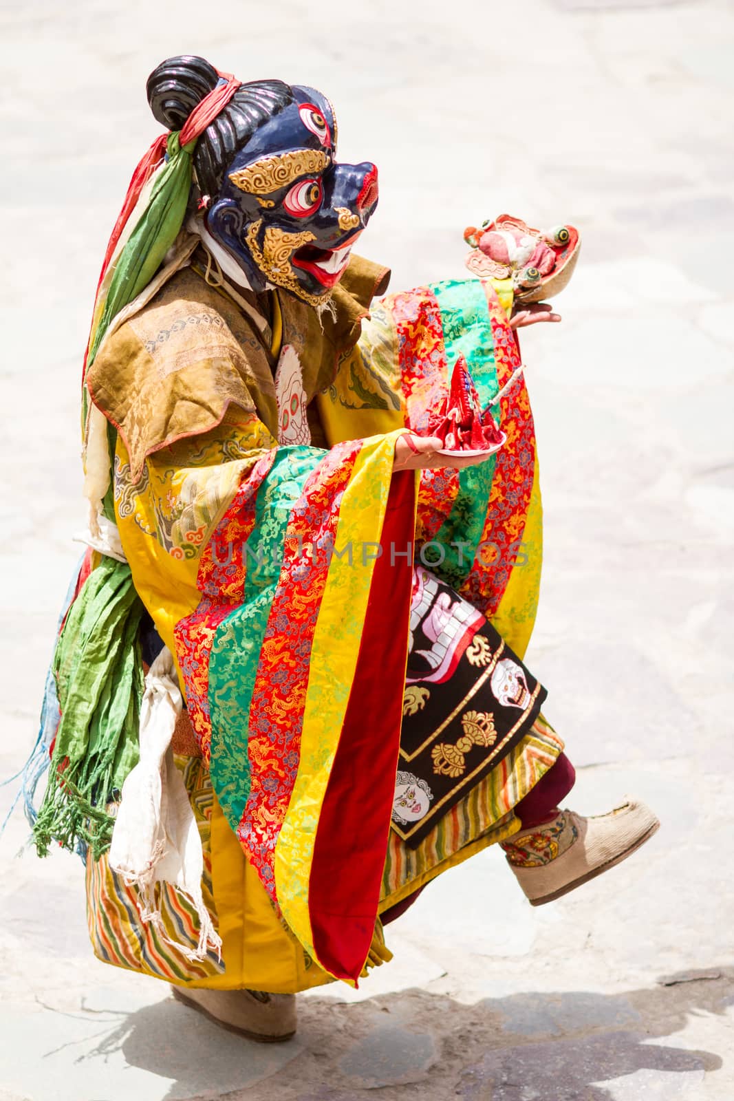 Unidentified monk performs a religious masked and costumed mystery dance of Tibetan Buddhism during the Cham Dance Festival in Hemis monastery, India.