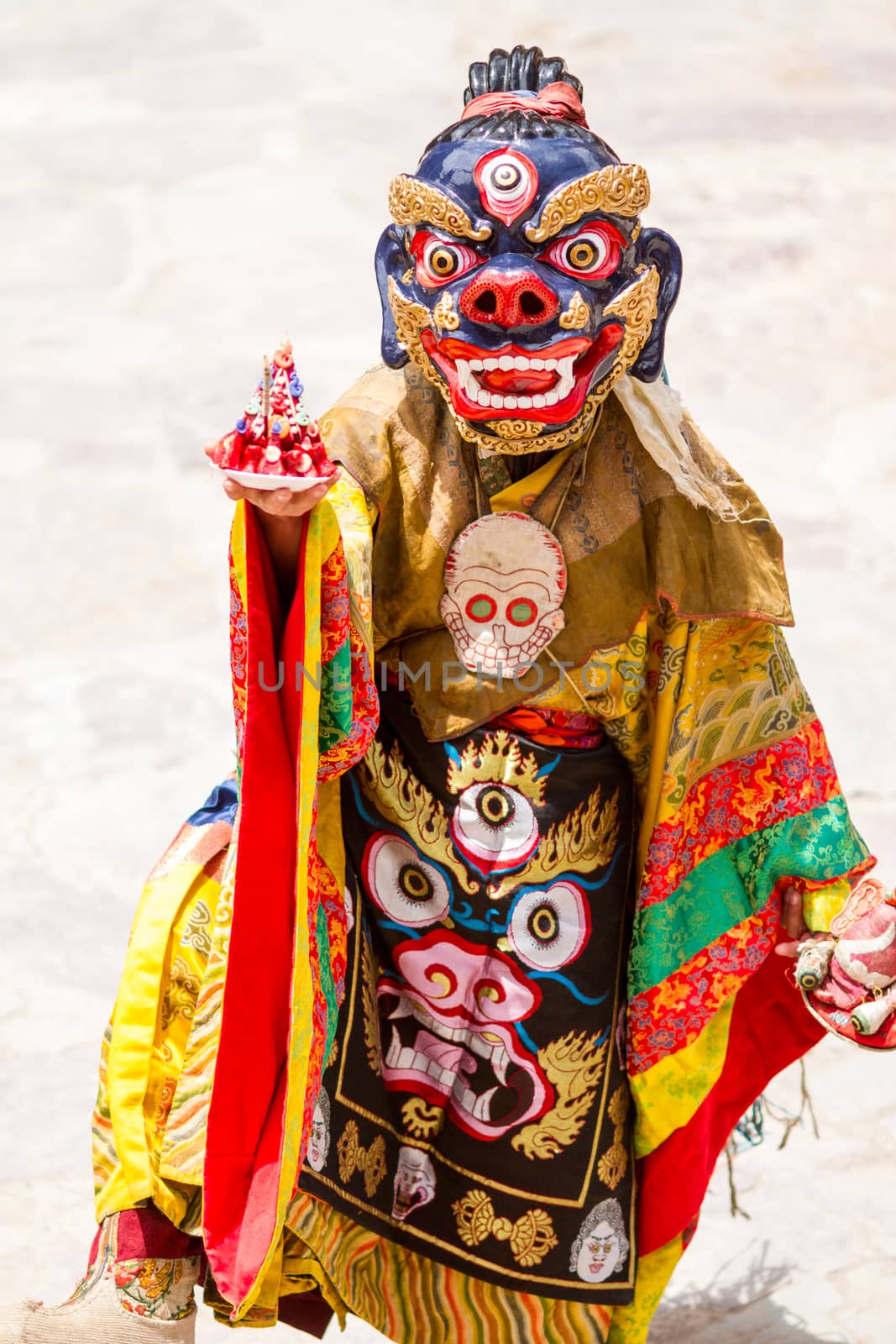 Monk performs a religious masked and costumed mystery dance of Tibetan Buddhism during the Cham Dance Festival by straannick