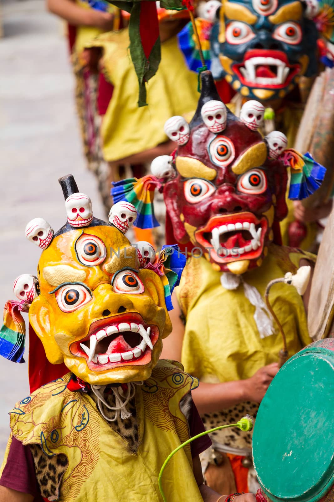 Unidentified monks with drums performs a religious masked and costumed mystery dance of Tibetan Buddhism during the Cham Dance Festival in Hemis monastery by straannick