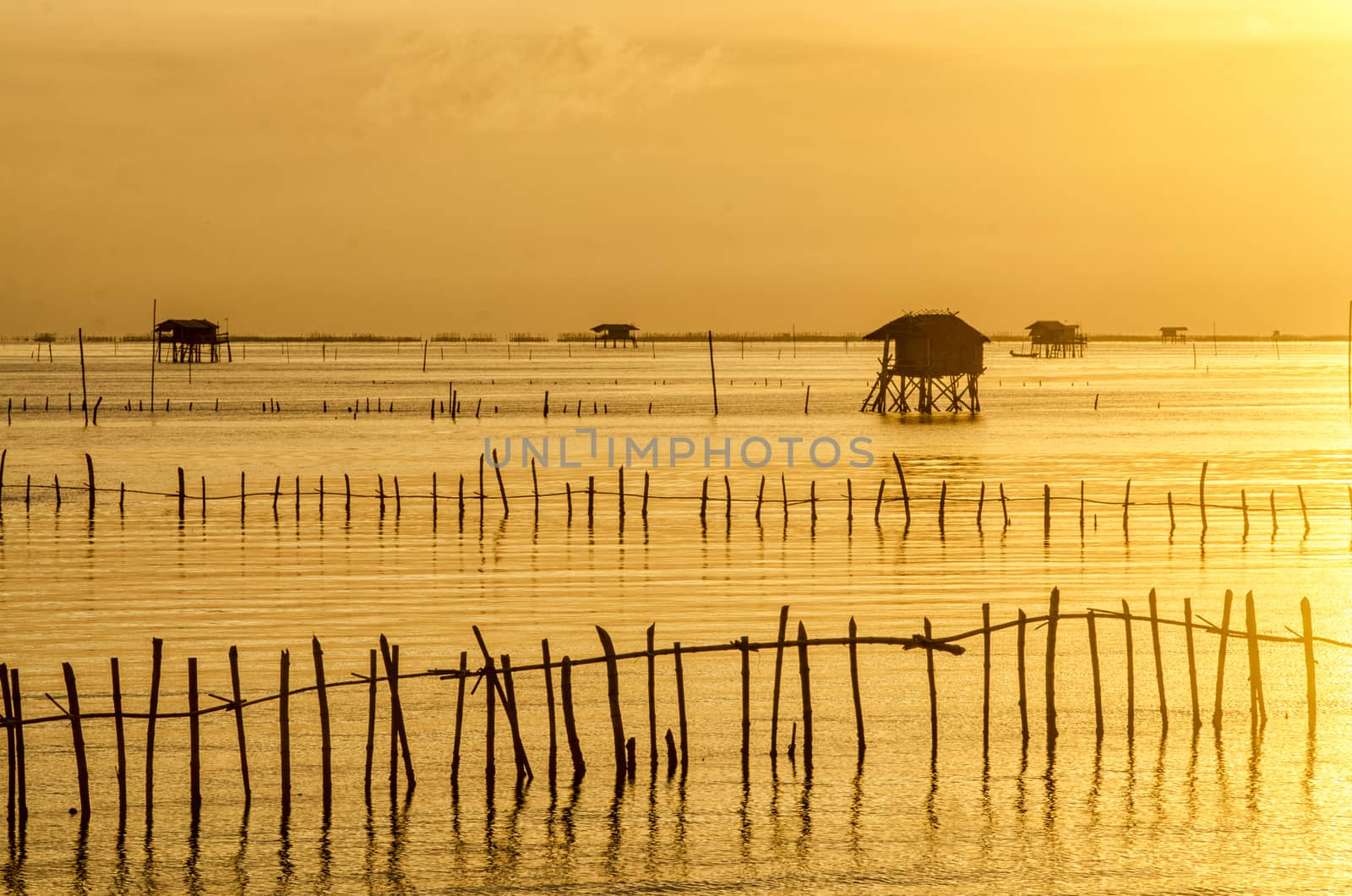 Sunrise time Thai fisherman village in Bangtaboon Petchaburi, Th by chanwity