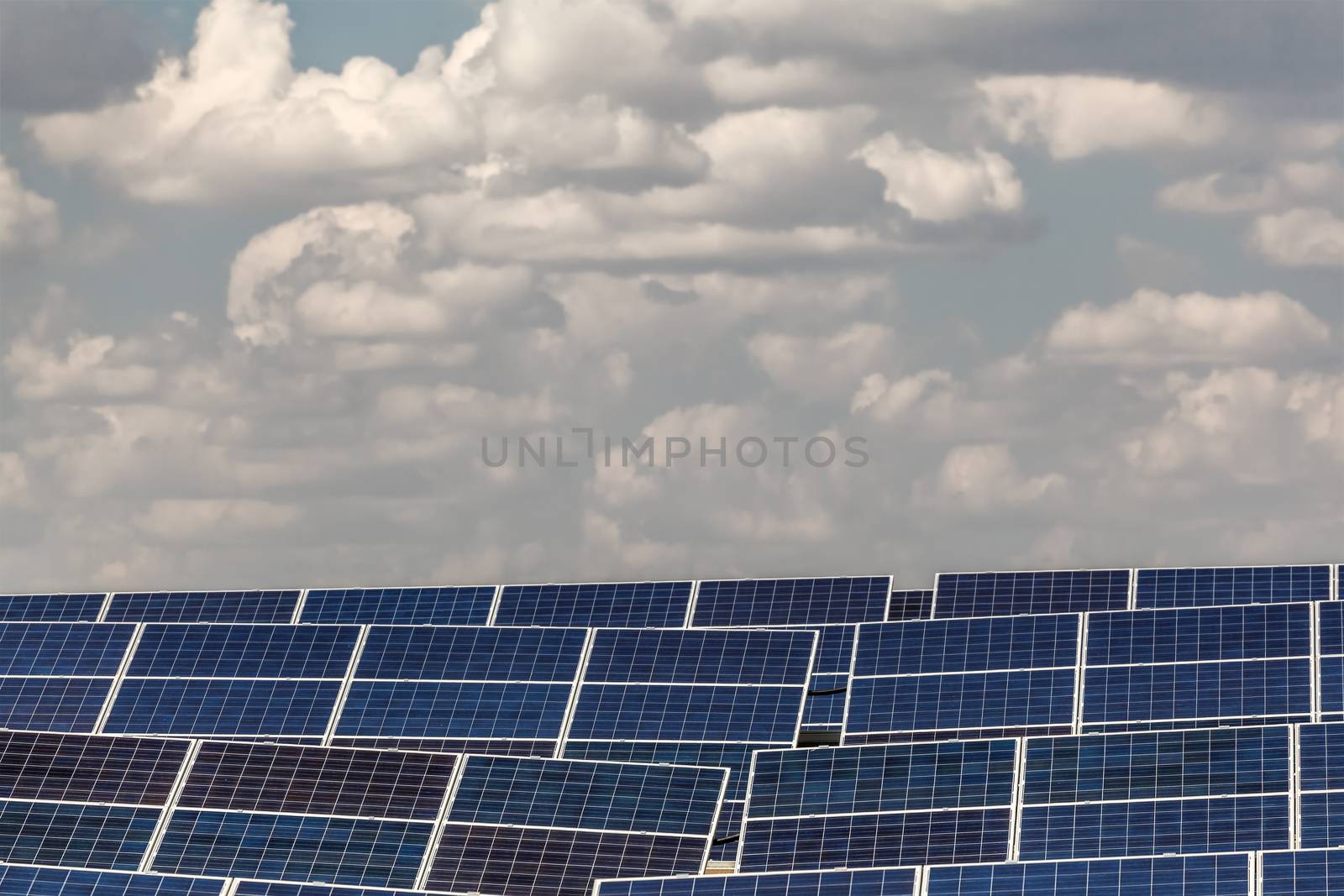 elements of solar power plants against the sky with clouds
