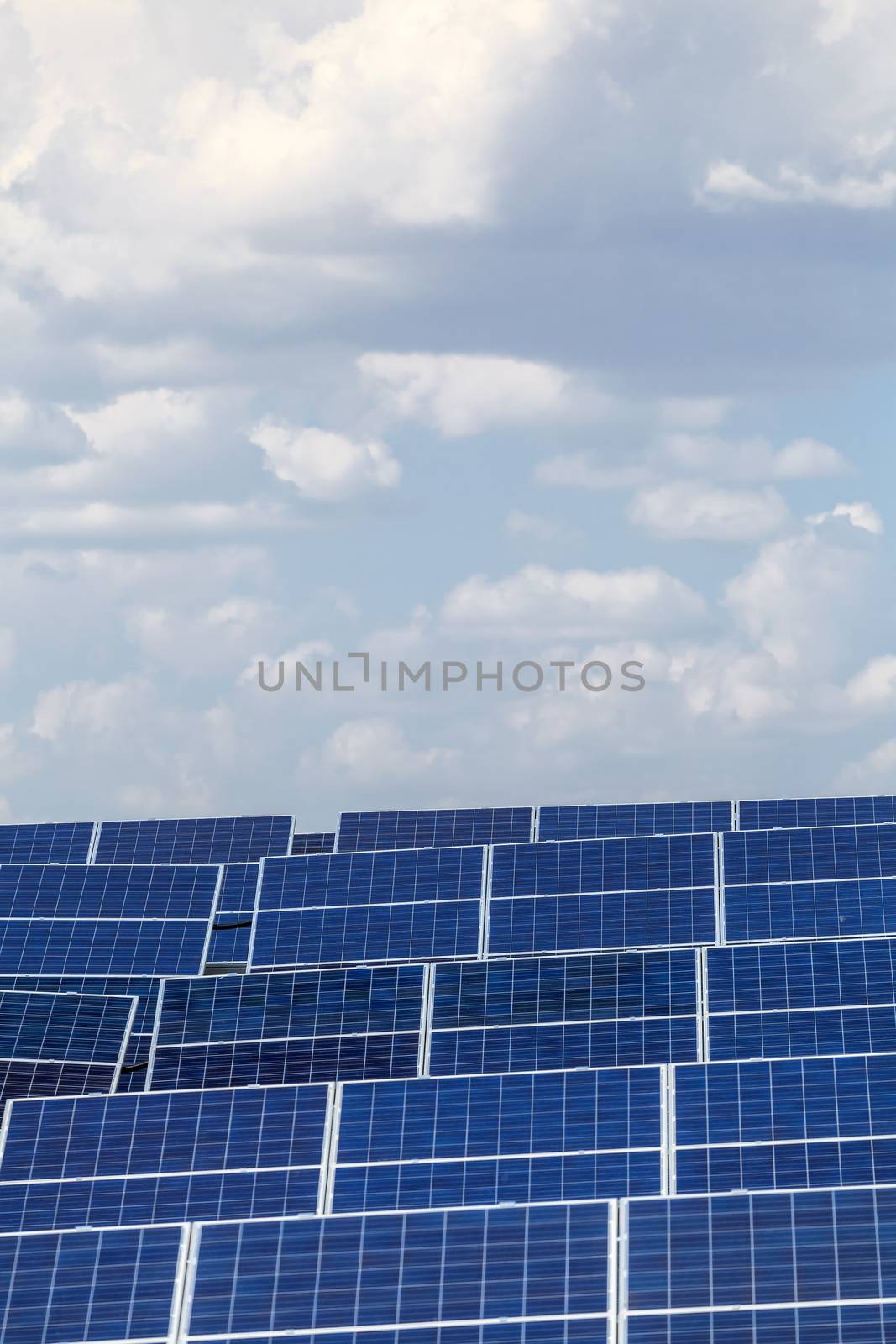 elements of solar power plants against the sky with clouds