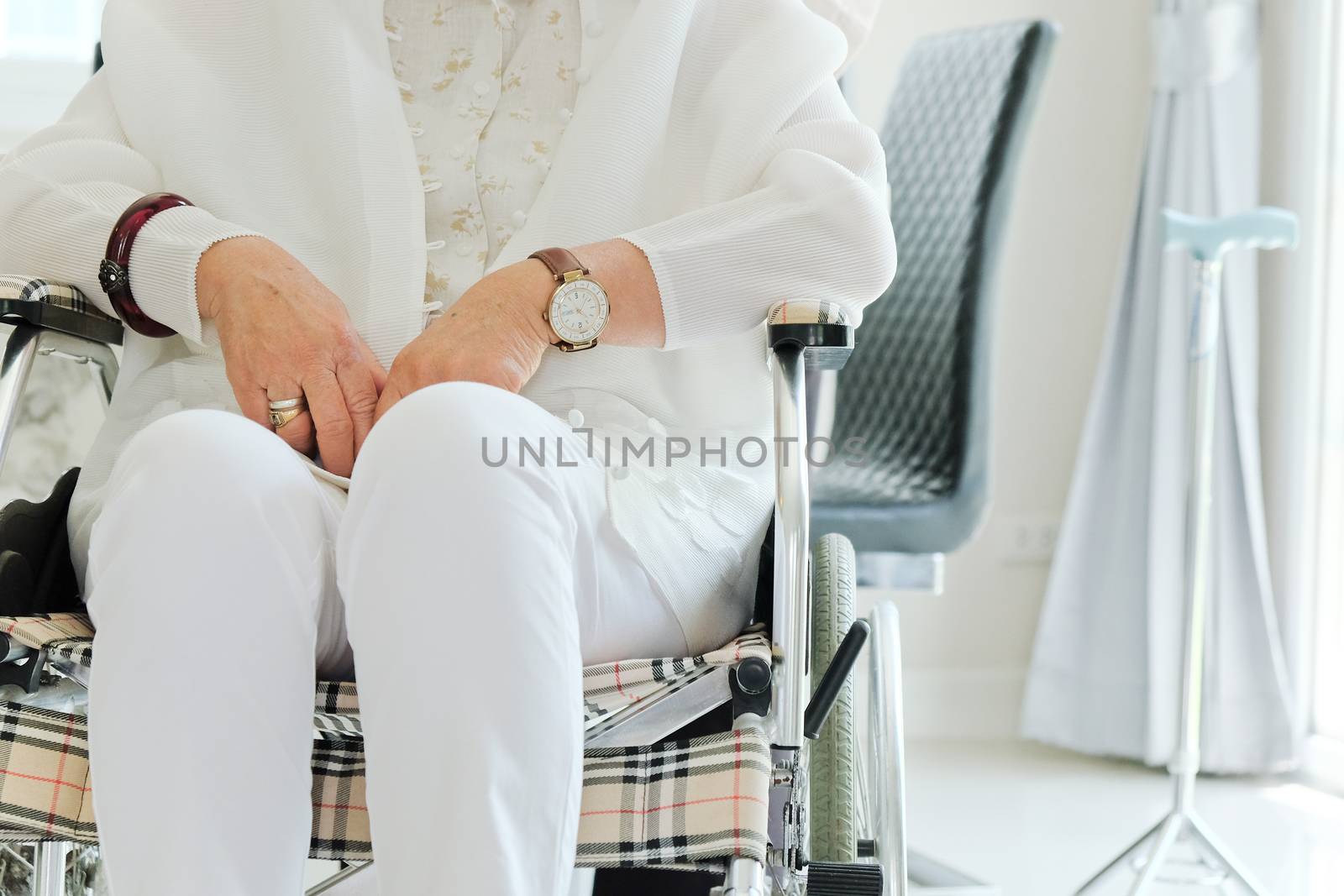 elderly woman in wheelchair background