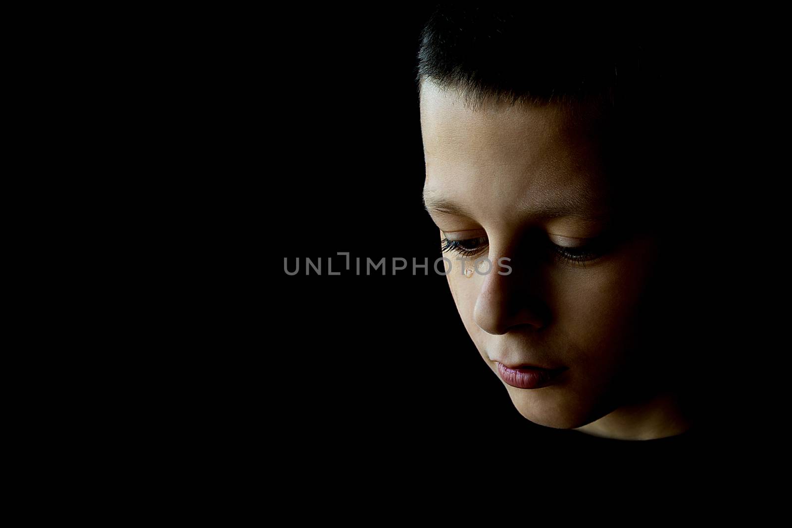 The Sad Boy With Tears in Their Eyes on a Black Background by Victority