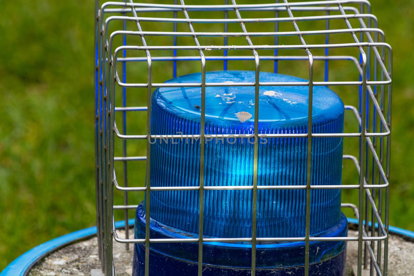 Blue flashing light, police siren  against destruction with wire sheathed.