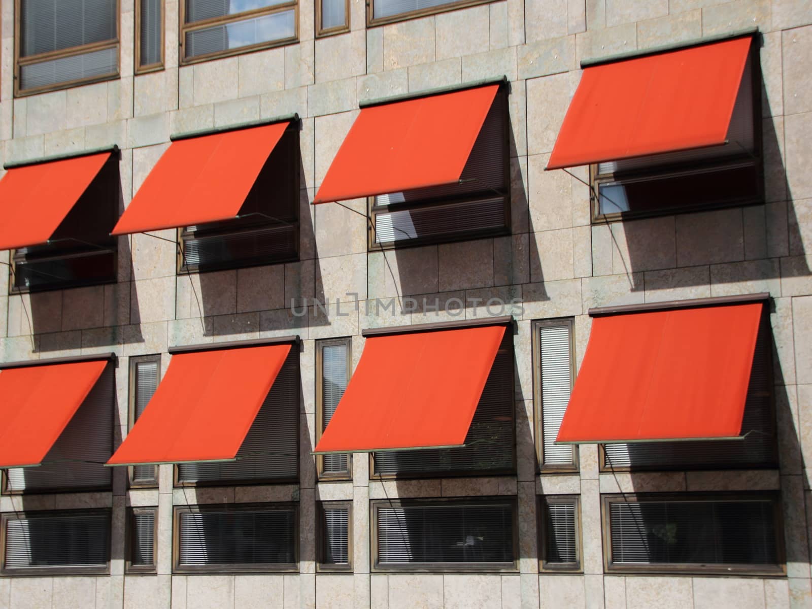 Red Overhang Sunshade Awning on Modern Building Facade Protecting from the Sun. Giving cooler indoor climate.