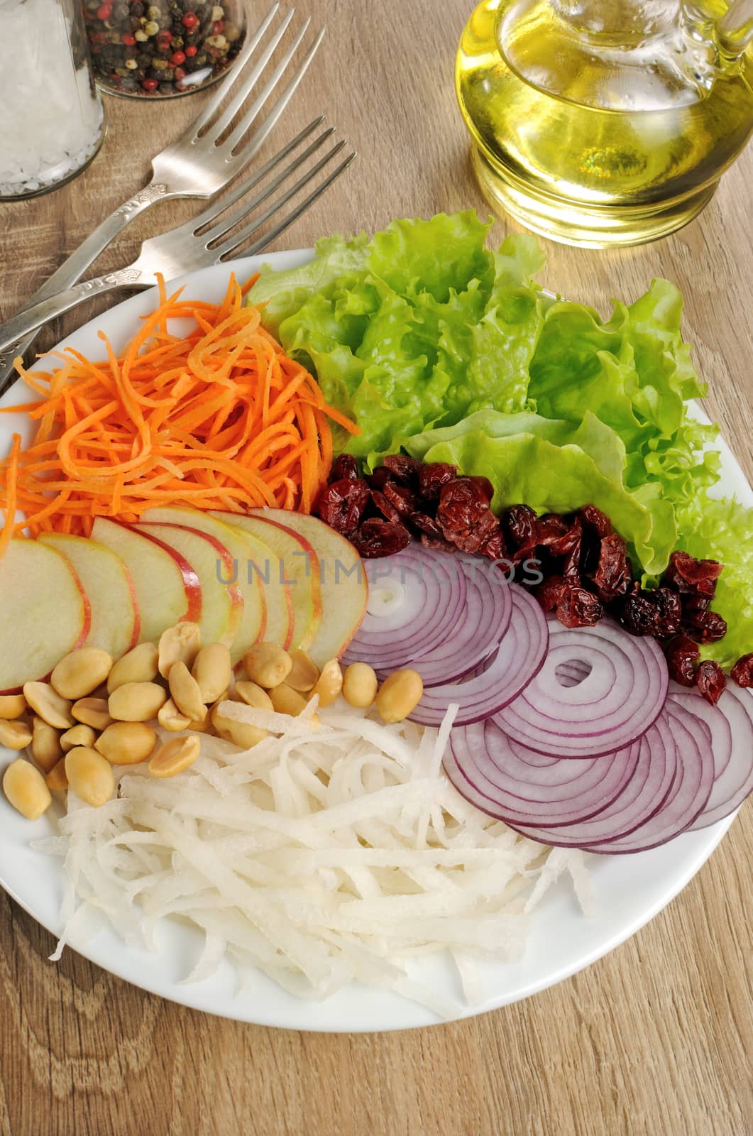 Dietary salad with apples, daikon, carrots, lettuce ,  cranberries and peanuts