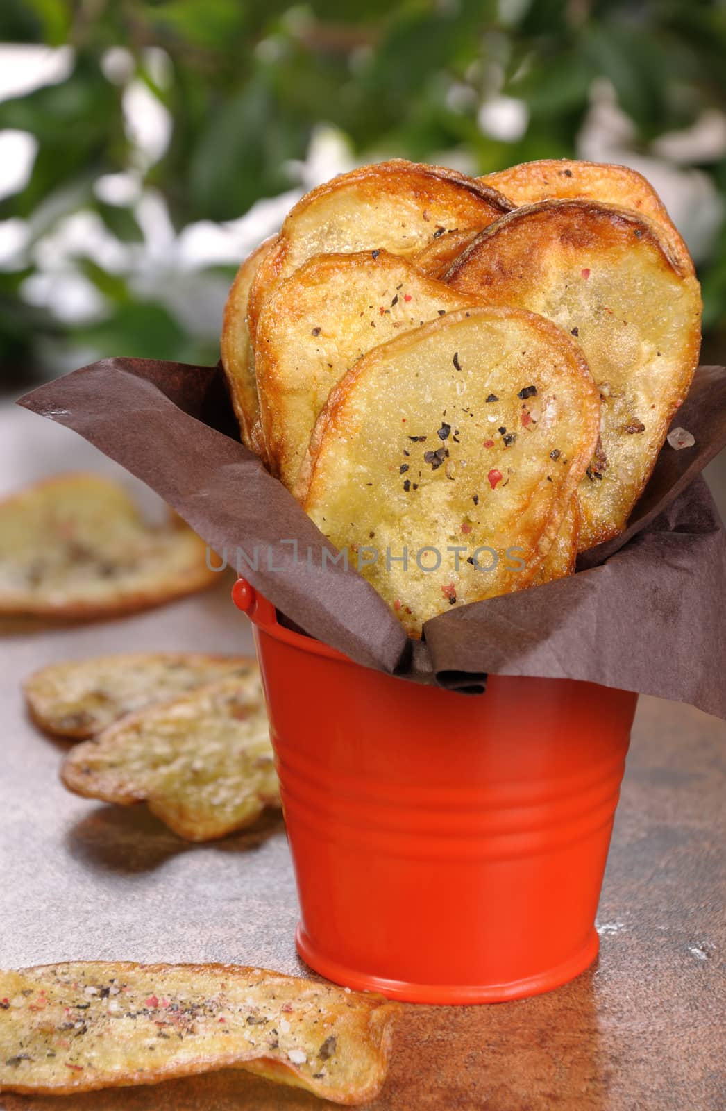 Homemade potato chips wrapped in paper and folded  bucket