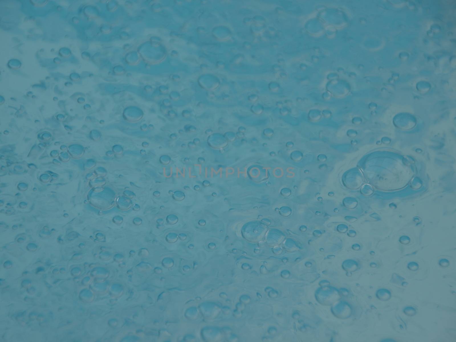 Perspective of Blue Swimming Pool Water Surface with Small Sparkling Bubbles