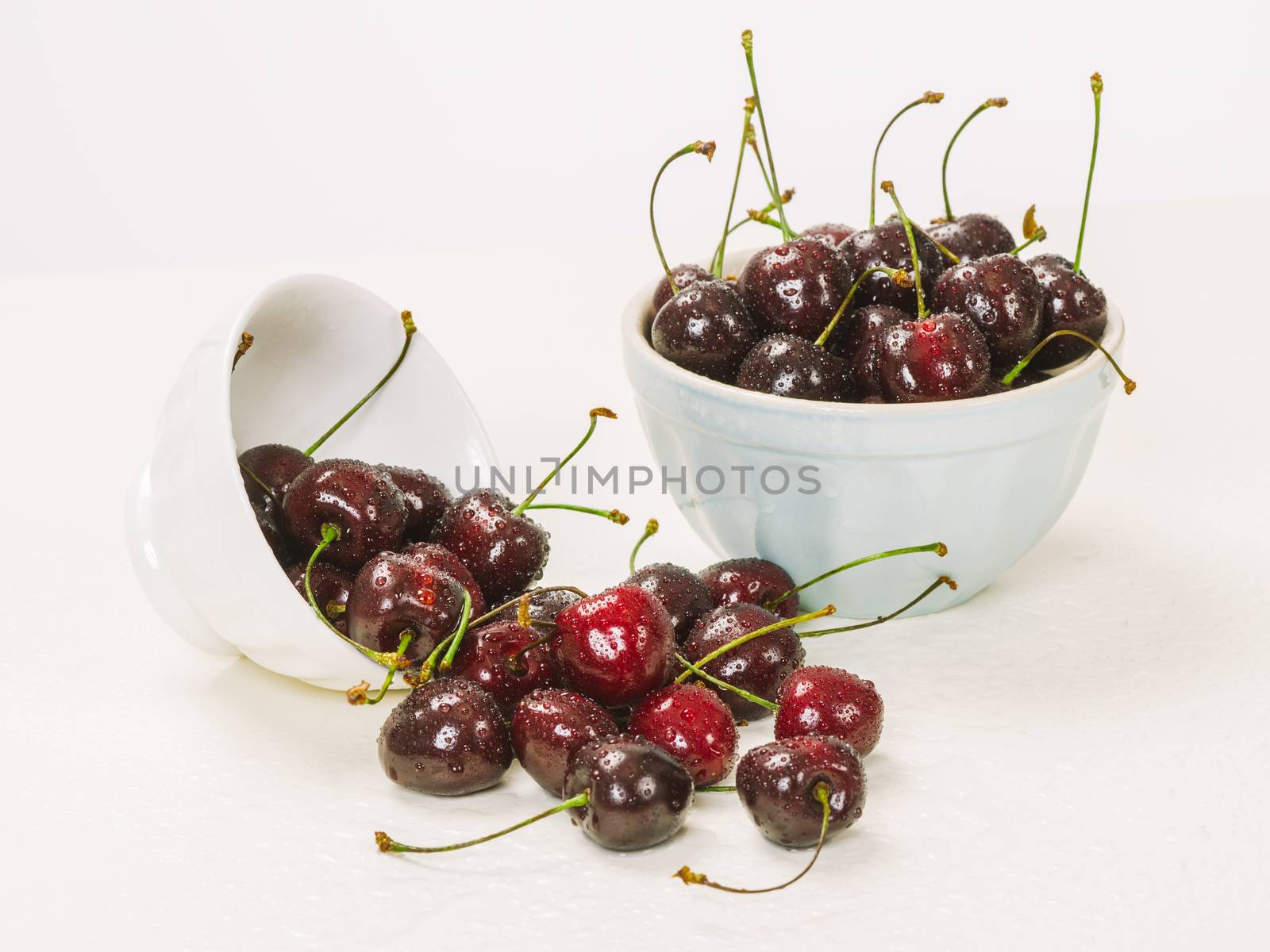 Bowls of wet cherries by sumners