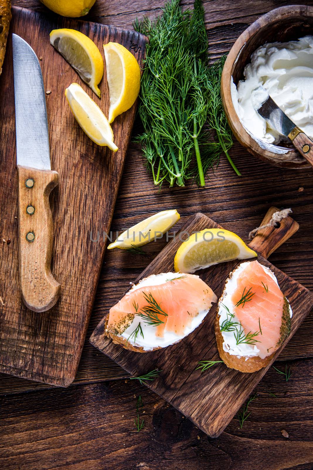 Fresh bread with smoked salmon in rustic kitchen