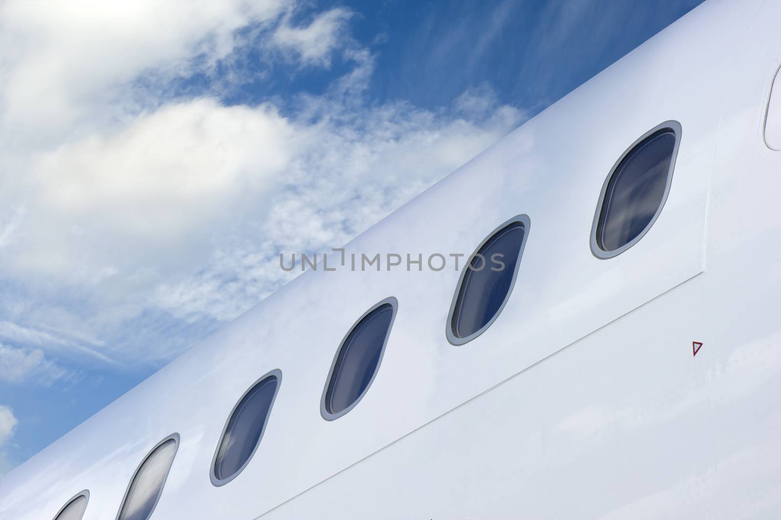 Row of Windows of an Airplane against blue sky