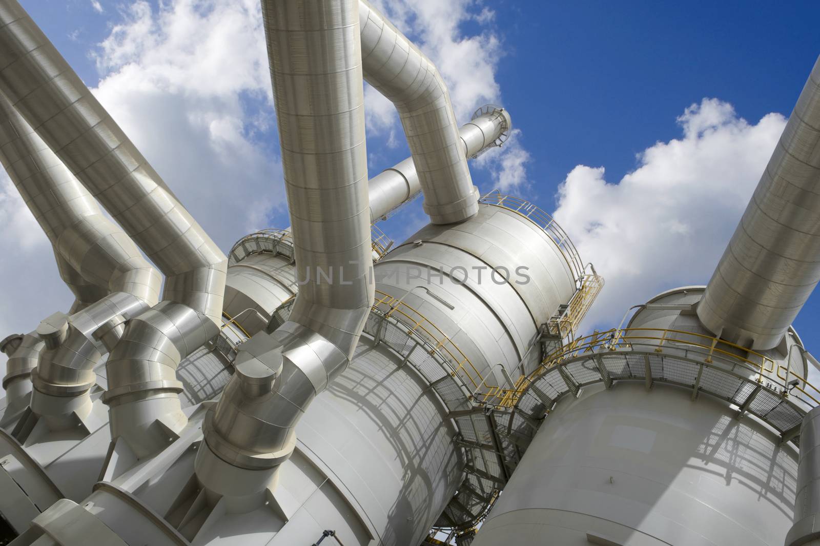 Industrial plant against blue cloudy sky