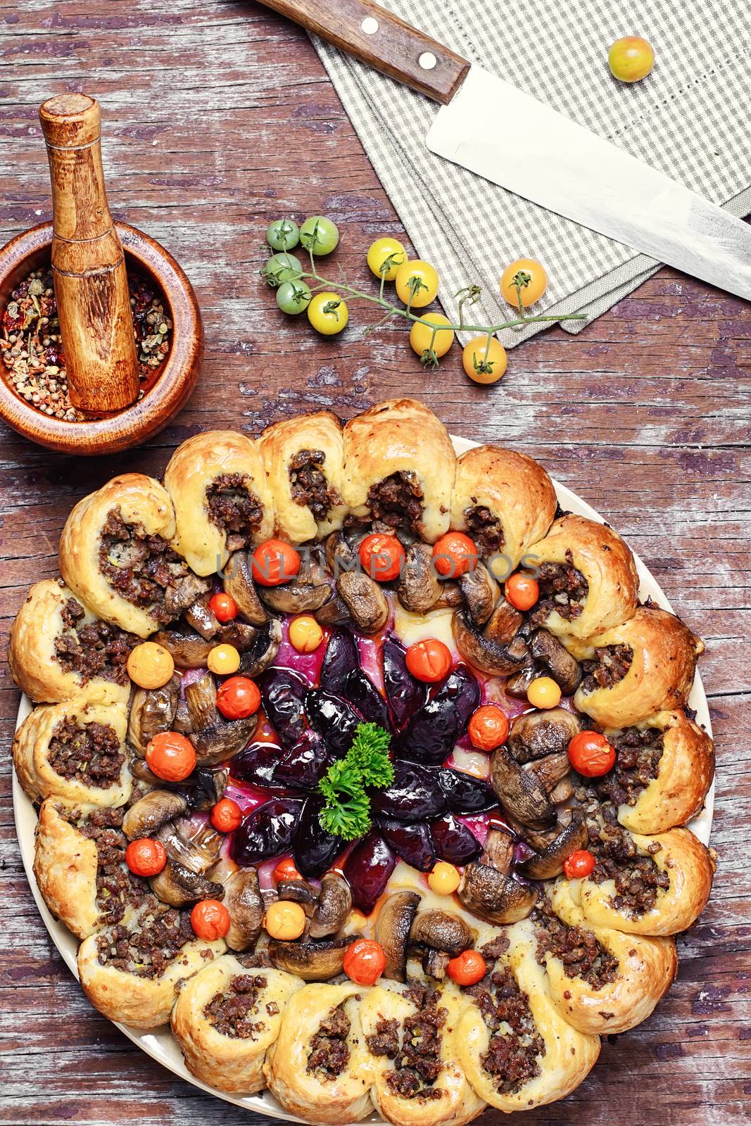 Delicious homemade steak pie with vegetables and plum jam in rustic style
