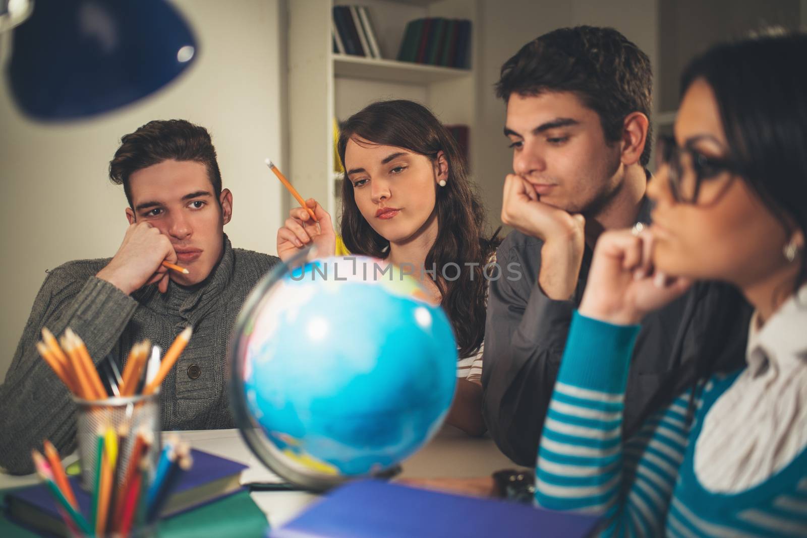 Four beautiful students of Geography learning with globe and thinking. Vintage concept.