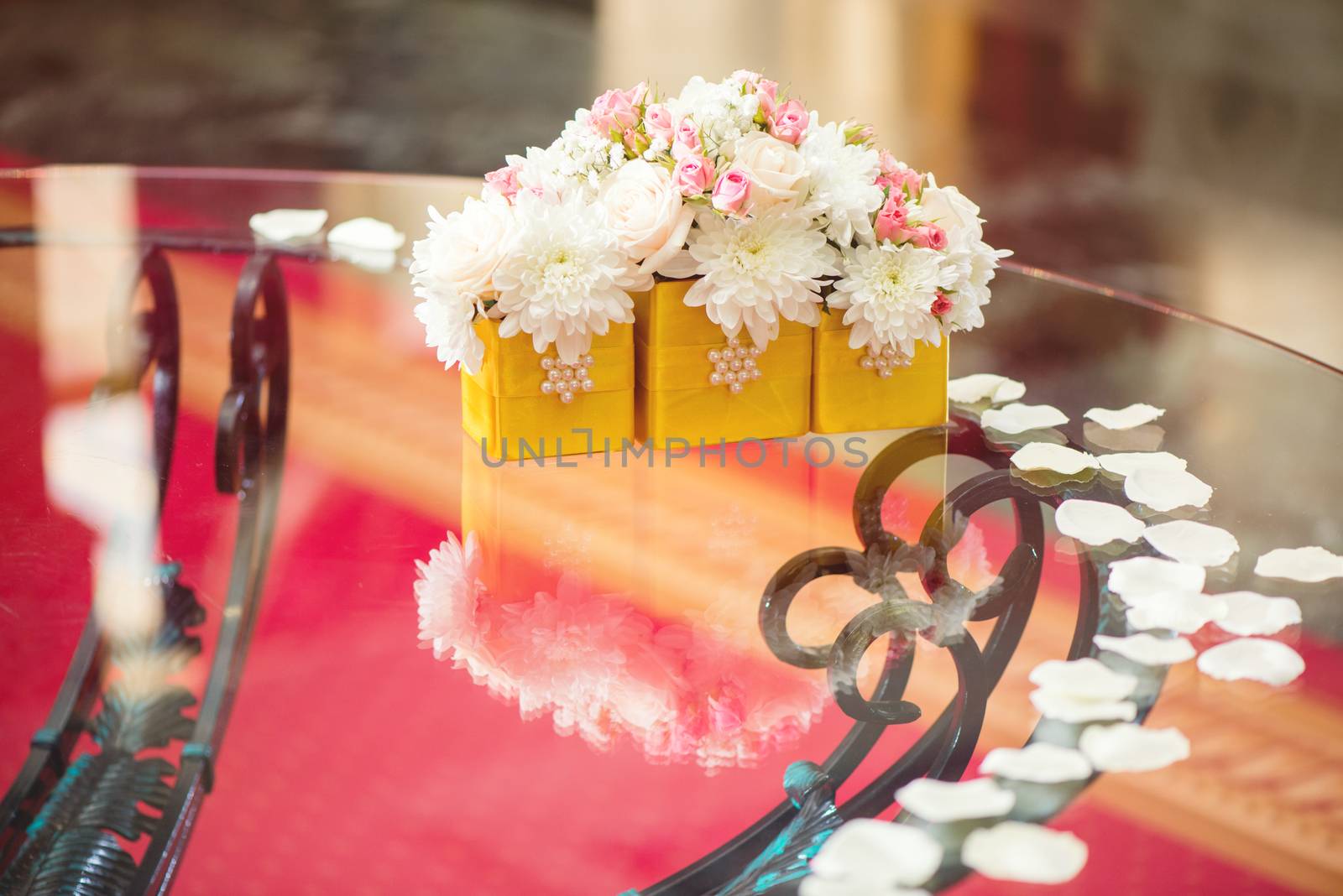 Wedding table decoration with white petals and flowers. Selective focus. 