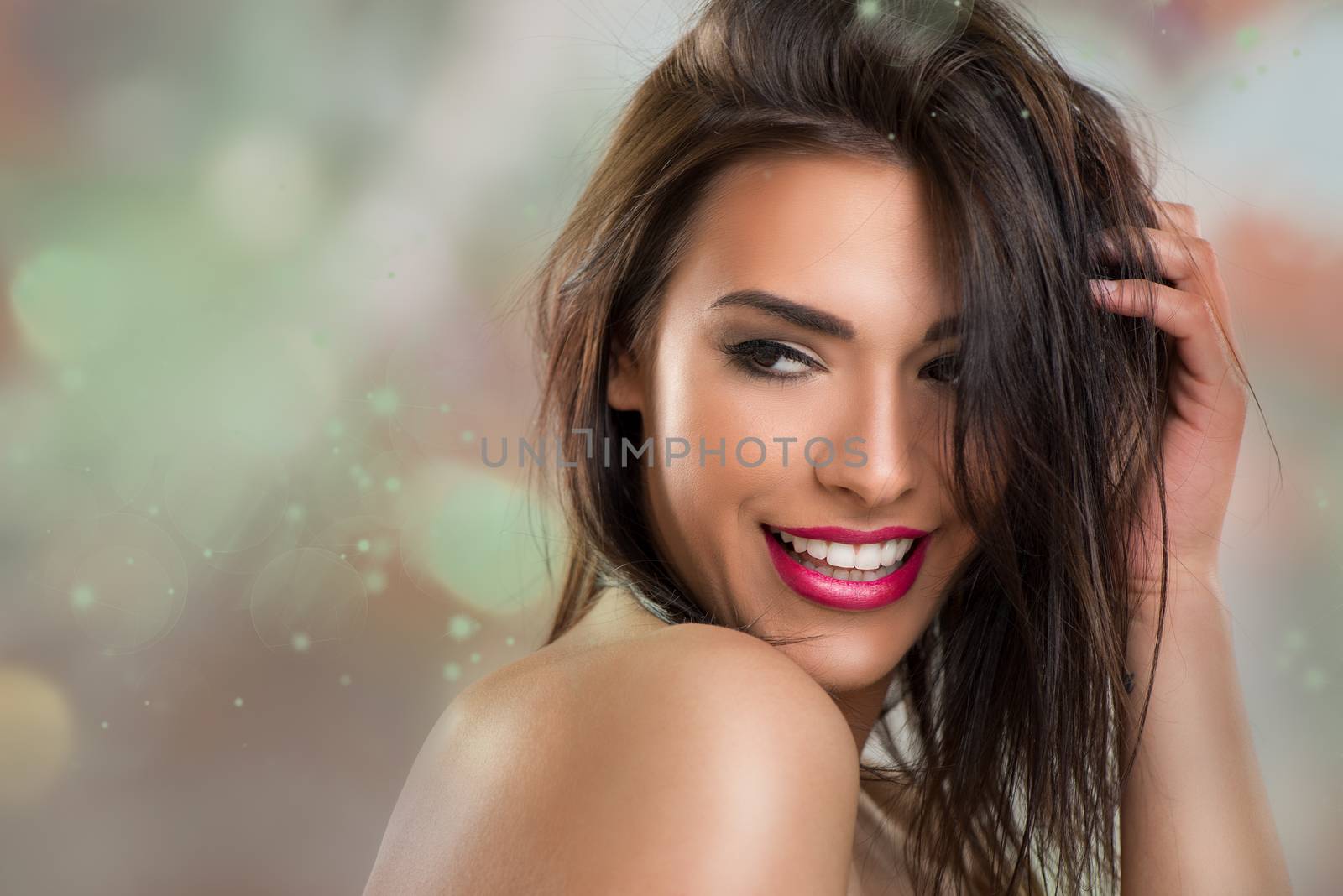 Portrait of a cute young brunette woman with perfect make-up and tousled hair