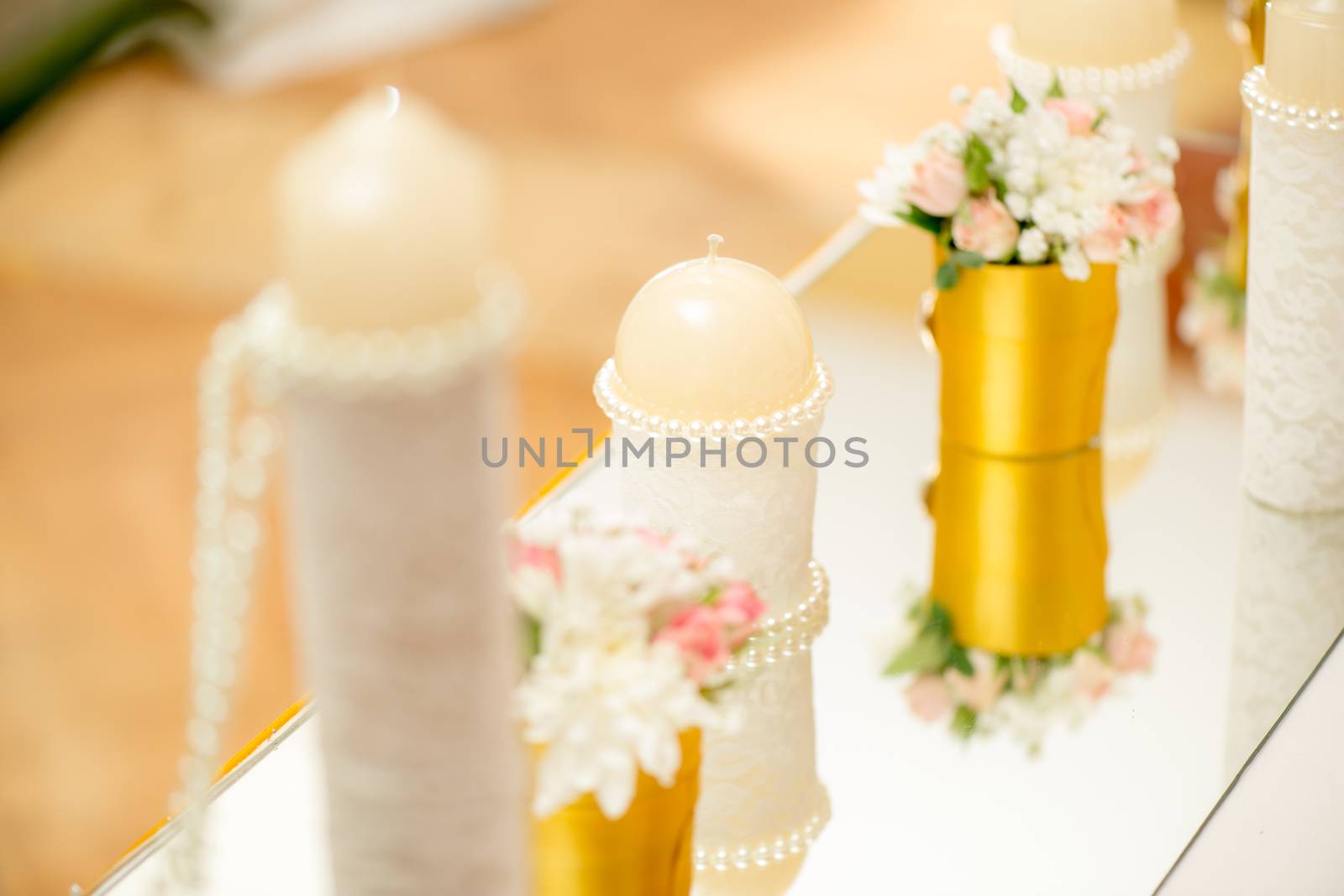 Wedding table decoration with candle, flowers and glassware