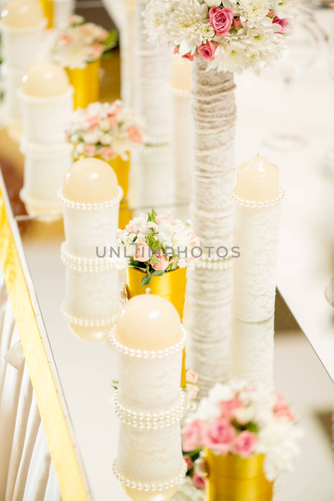 Wedding table decoration with candle, flowers and glassware