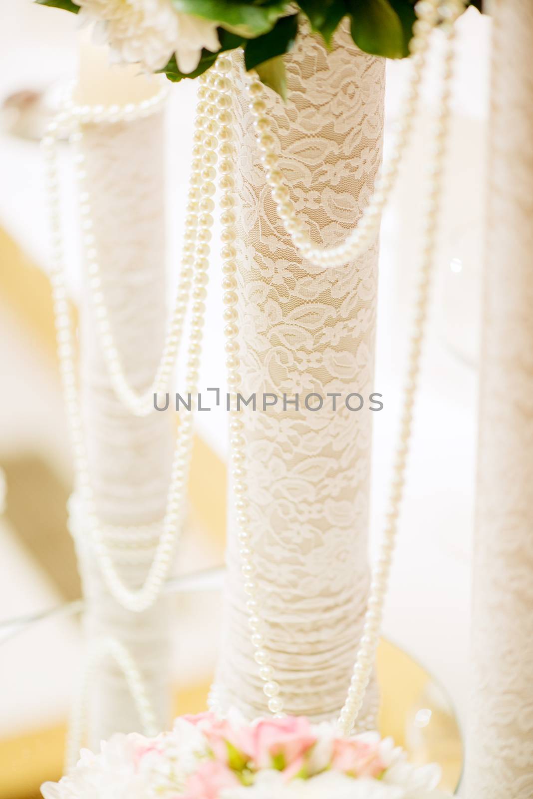 Wedding table decoration with pearls and lace
