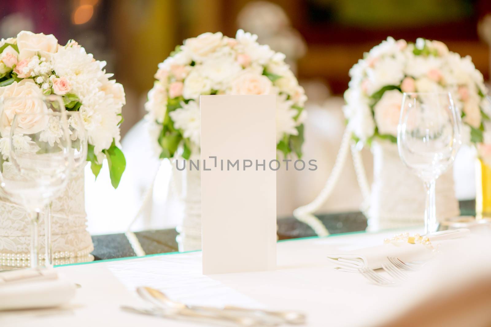 Close-up of a floral wedding table decoration with menu