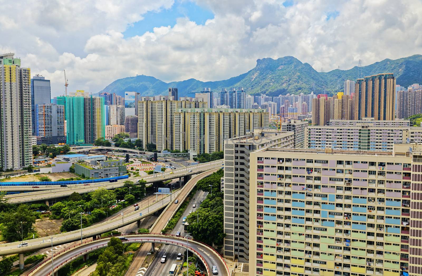 hong kong public estate with landmark lion rock at day by cozyta