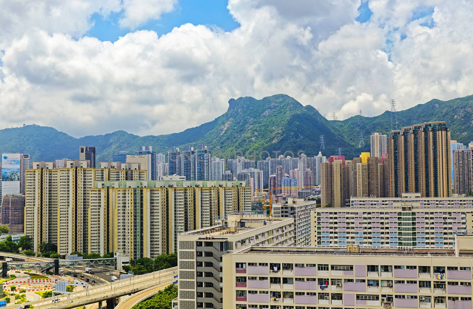 hong kong public estate with landmark lion rock at day by cozyta