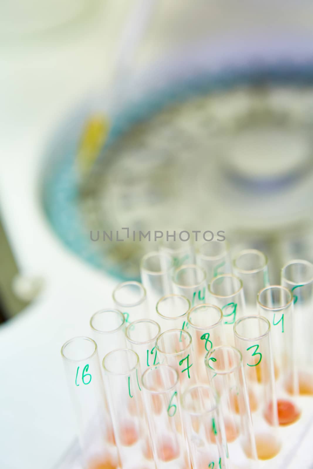 pipette dropping sample into a test tube,abstract science background by sarymsakov