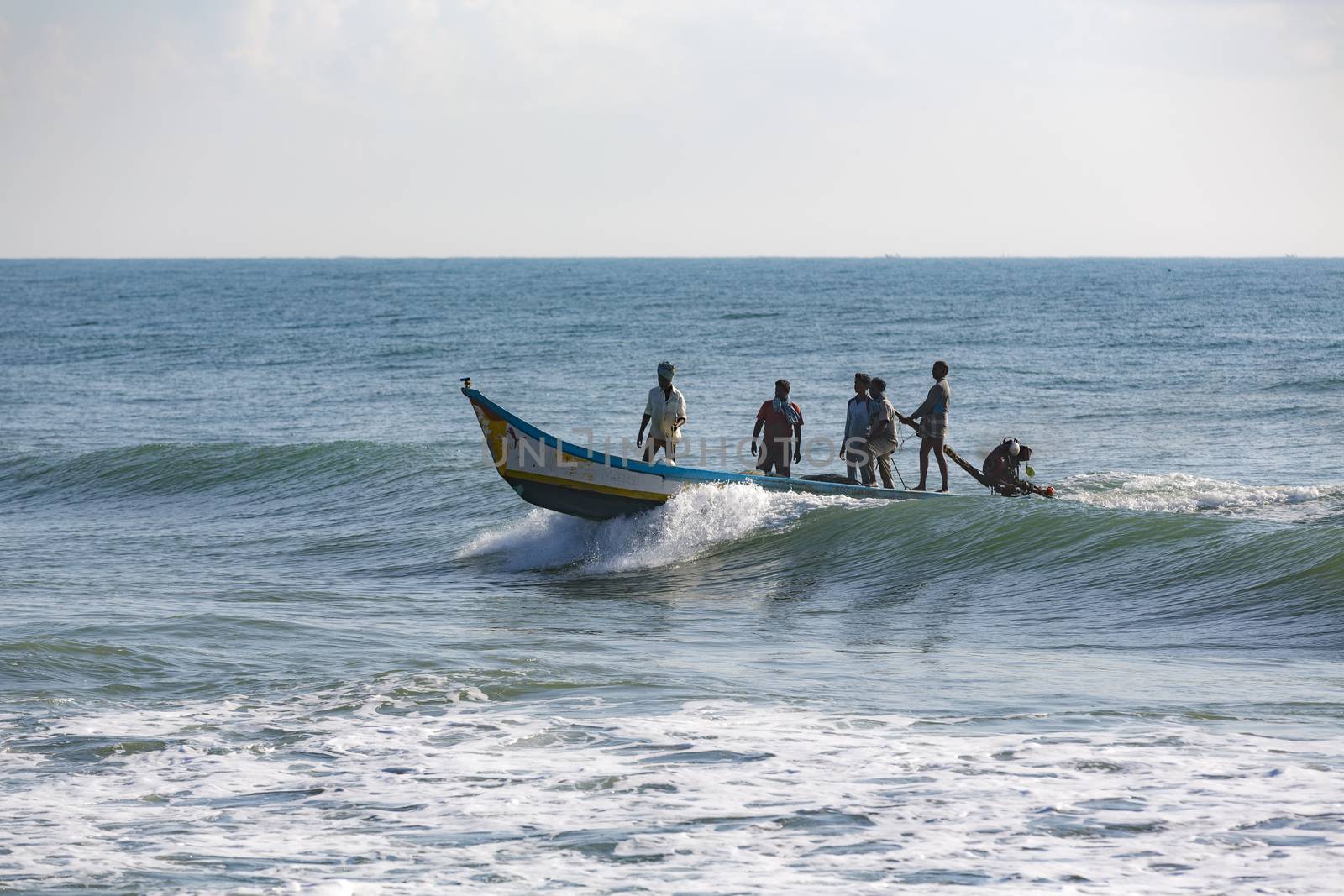 Pondichery, Tamil Nadu, India - February 27, 2014 : Traditional fishermen on beach, on sea, on sand. Long boats, Hard work poor people